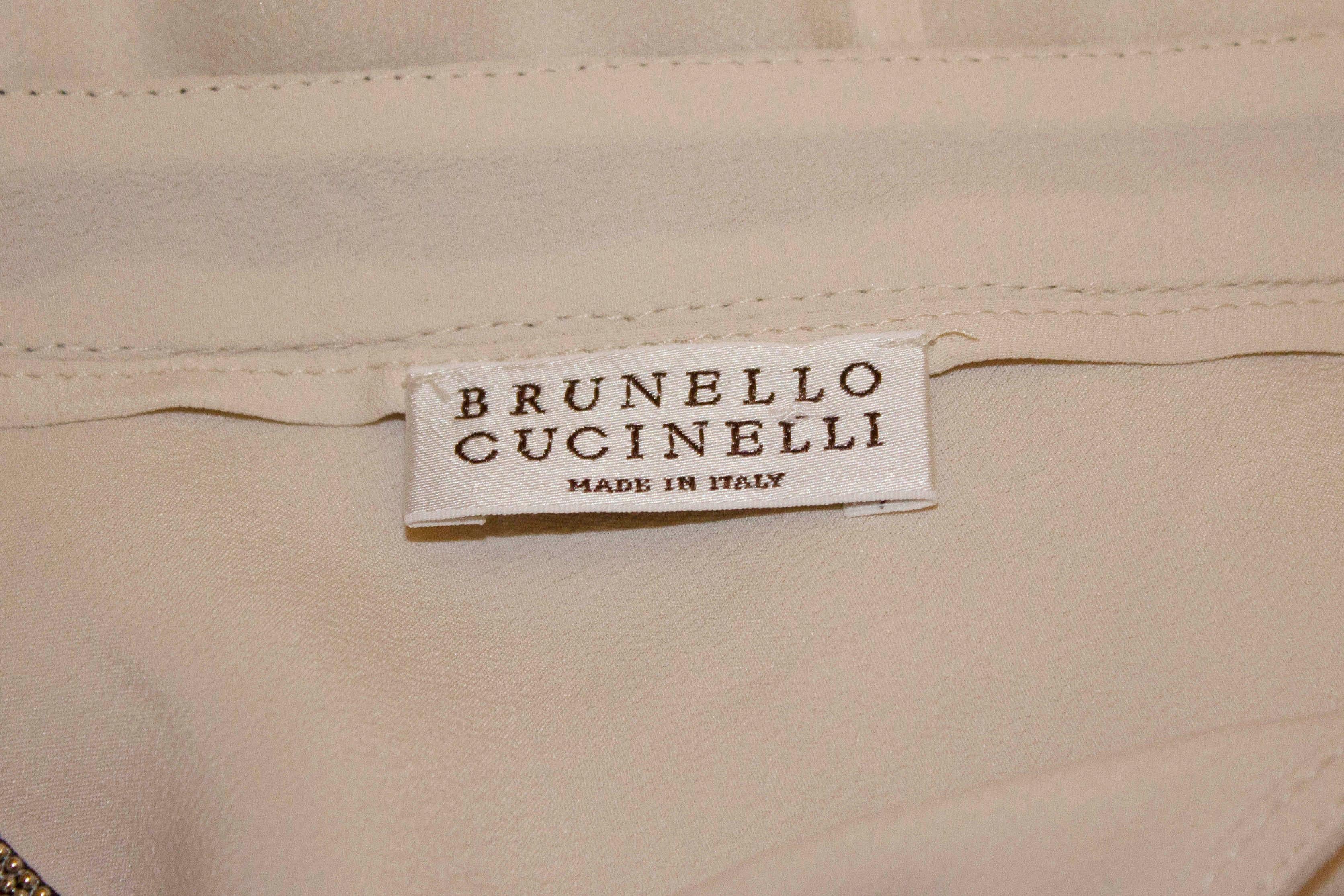 A wonderful silk dress for wafting, by Brunello Cucinelli.  In ivory silk with a decorated neckline, this silk is great for Summer parties.