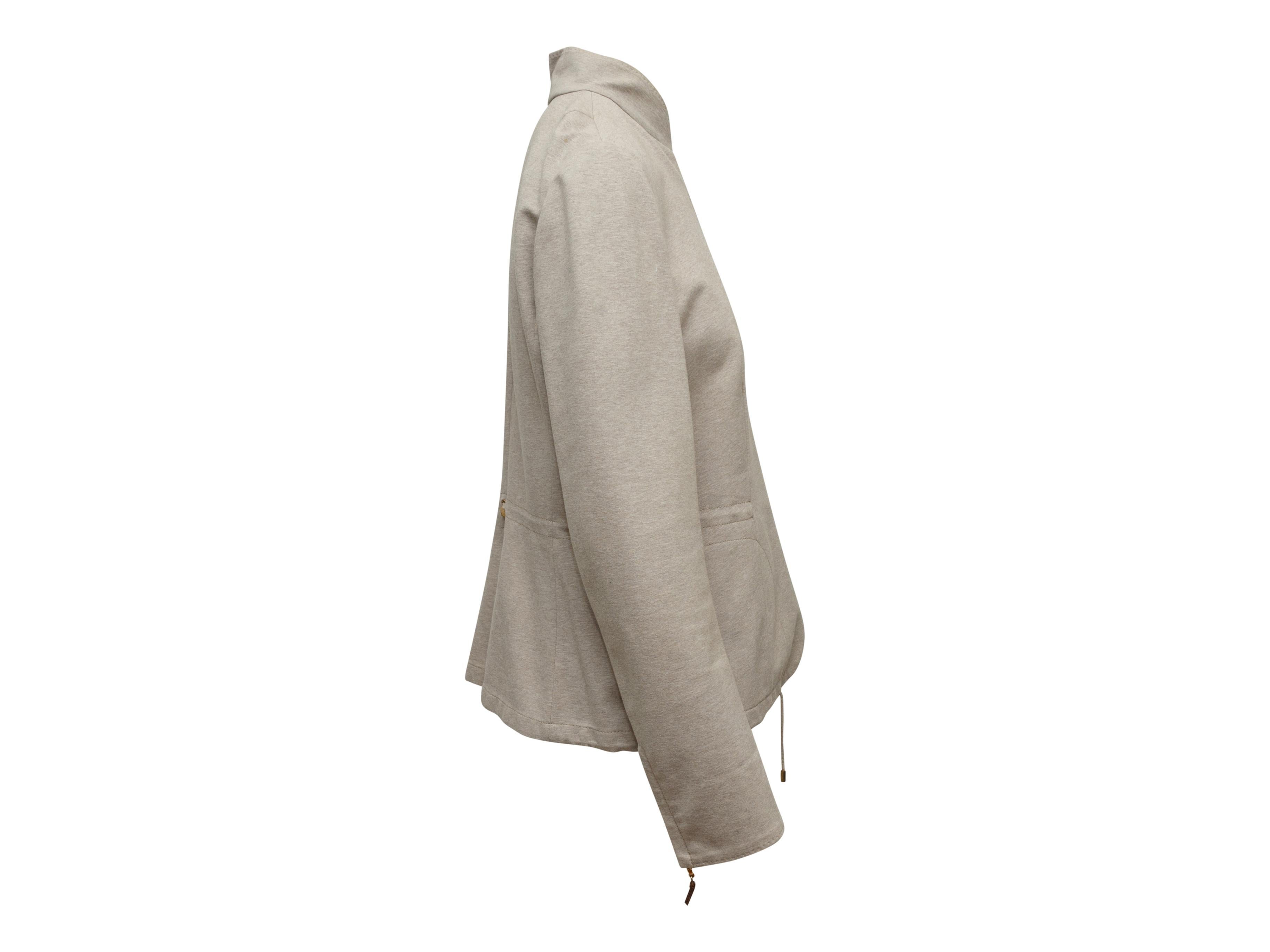 Product details: Light brown lightweight jacket by Brunello Cucinelli. Mandarin collar. Drawstring at waist and hem. Button closures at front. 36