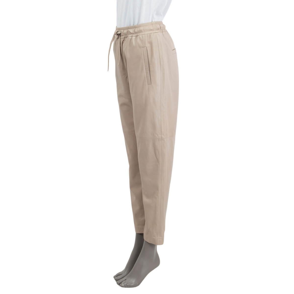 100% authentic Brunello Cucinelli 'Pull On' jogging pants in taupe leather (100%). Feature two side slit pockets and two sewn shut slit pockets on the back. Open with a drawstring on the front. Lined in sage acetate (65%) and polyester (35%). Have