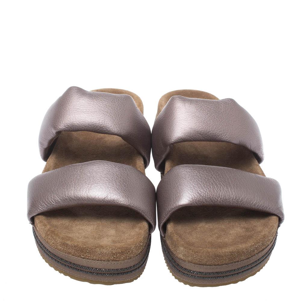 Pair your favorite outfit with these Brunello Cucinelli flats for a smart look. Step out in these impressive metallic leather slides to channel your effortless style. They have cushioned vamp straps, platforms, open toes, suede-lined insoles, and