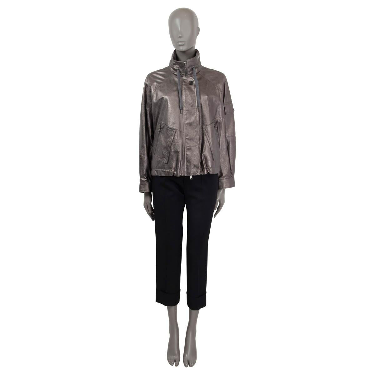 100% authentic Brunello Cucinelli stand collar bomber jacket in metallic silver leather (100%). Features long raglan sleeves (sleeve measurements taken from the neck) and buttoned cuffs. Has a hidden hood and a drawstring closure at the neck and the