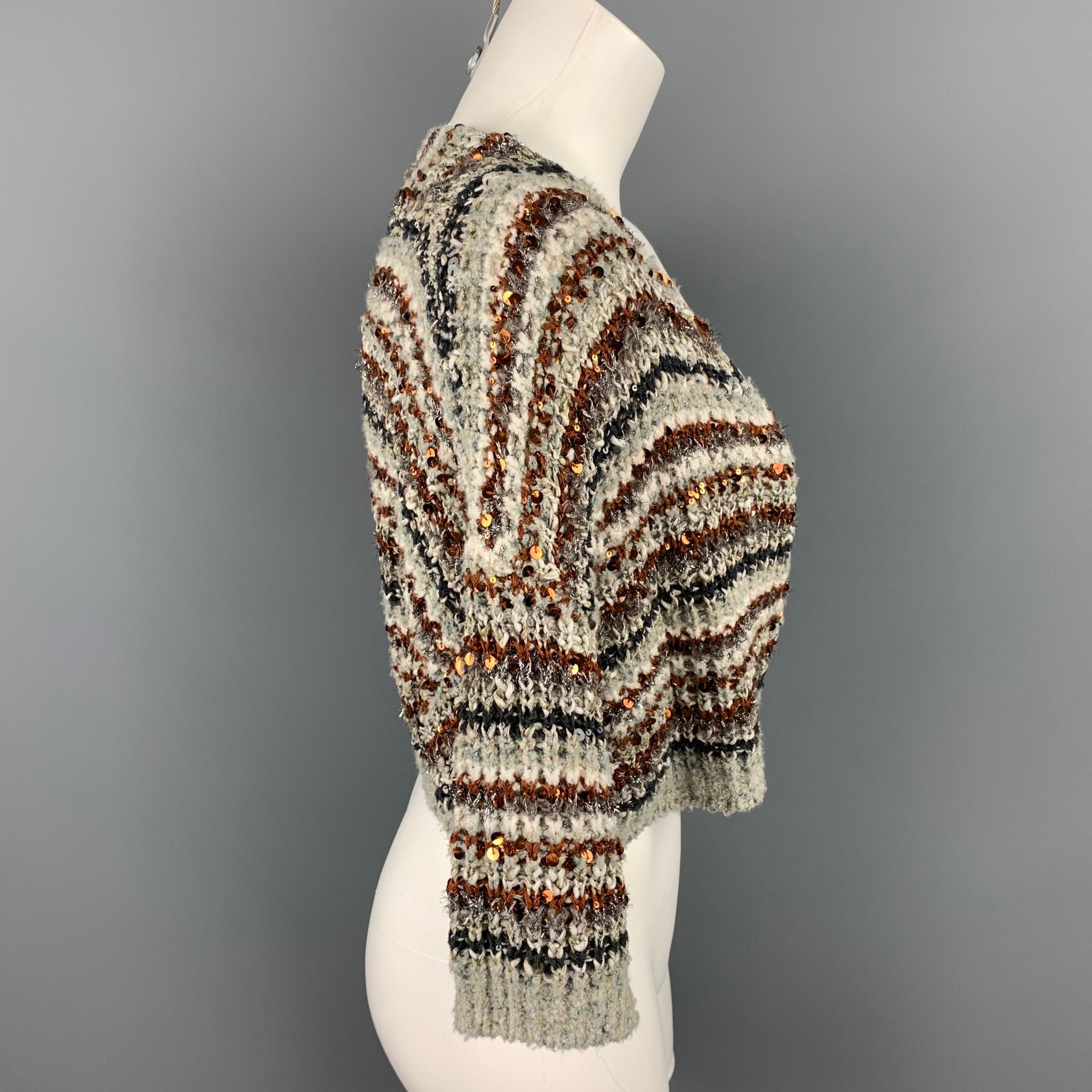 BRUNELLO CUCINELLI cardigan comes in a multi-color sequin cotton blend featuring a cropped style and a snap button closure. Made in Italy.

Very Good Pre-Owned Condition.
Marked: No size marked
Original Retail Price: