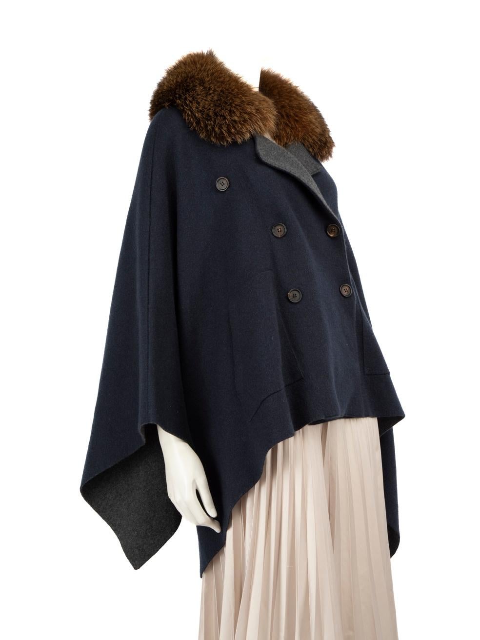 CONDITION is Very good. Minimal wear to the cape is evident. The snap button on the inside to secure the sleeves is loose. The snap button on the right front panel to secure the wrap-over is also missing on this used Brunello Cucinelli designer