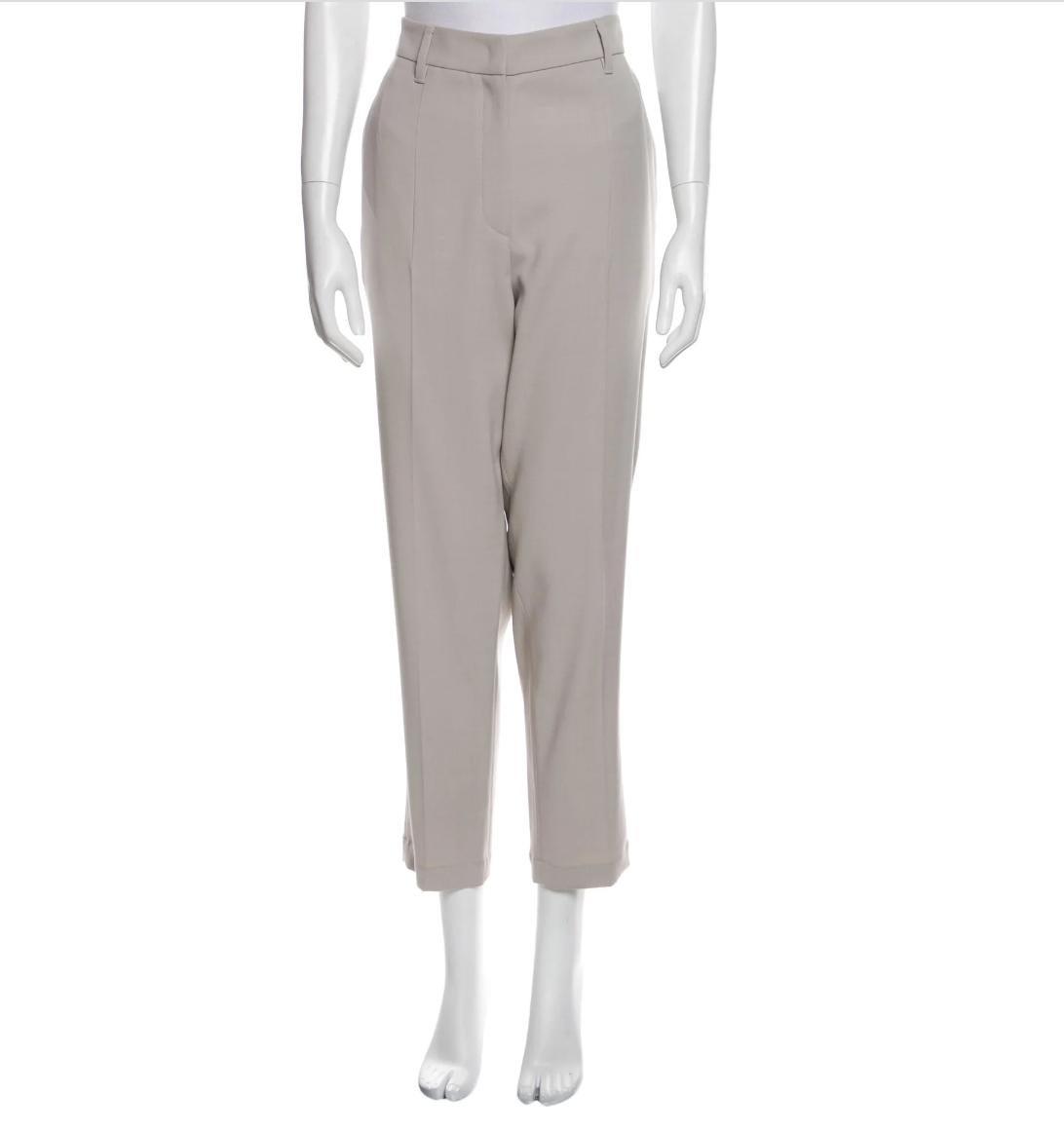Acetate cropped straight leg pants by Brunello Cucinelli in neutral grey color. 
High-Rise
Slit Pockets
Zip & Button Closure
Size: M
Composition: 52% Acetate, 48% Silk; Lining 68% Acetate, 32% Polyester
Measurements: