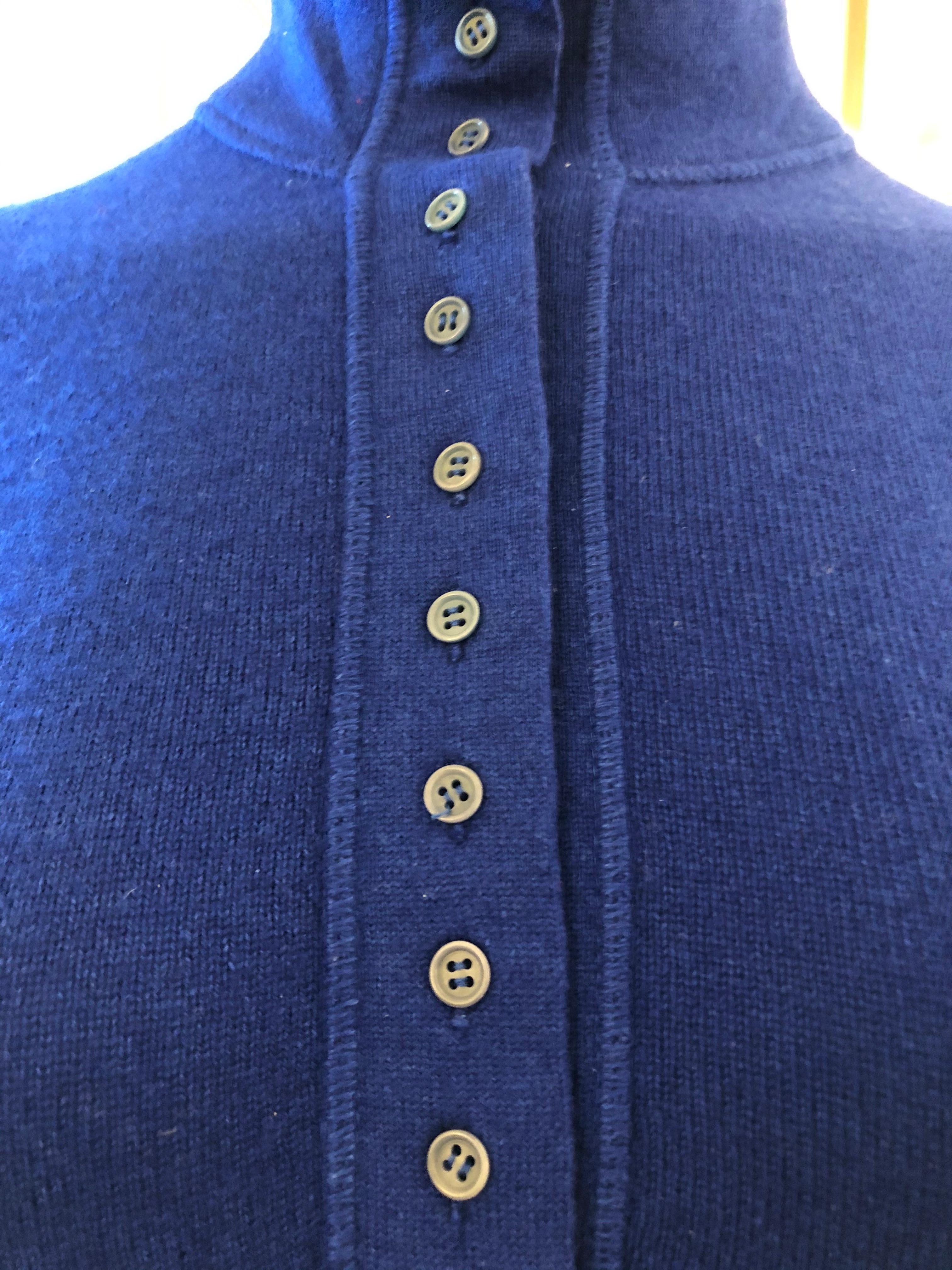 Wear it up or wear it down, this is a beautifully made sweater of the finest quality. The high neckline can be folded as in the pictures and the buttons can accommodate your style. The hems are ribbed and there are exposed seams.