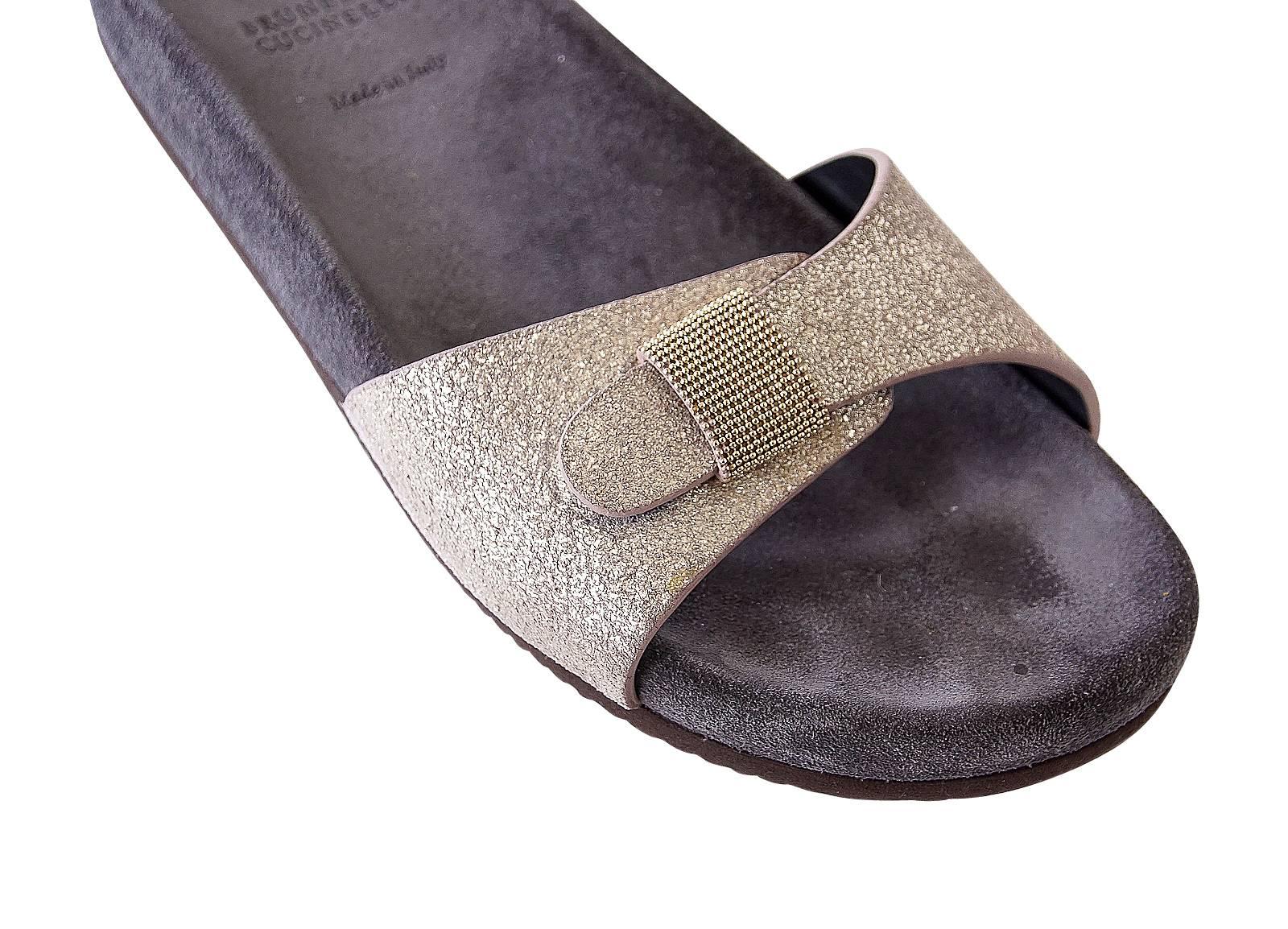 Guaranteed authentic Brunello Cucinelli soft metallic gold silvery slide.
Soft toned gold slide with signature beading on strap.
Inner sole is brown suede. 
Sandal was worn once indoors.
final sale

SIZE 37.5
USA SIZE 7.5

SHOE MEASURES:
HEEL