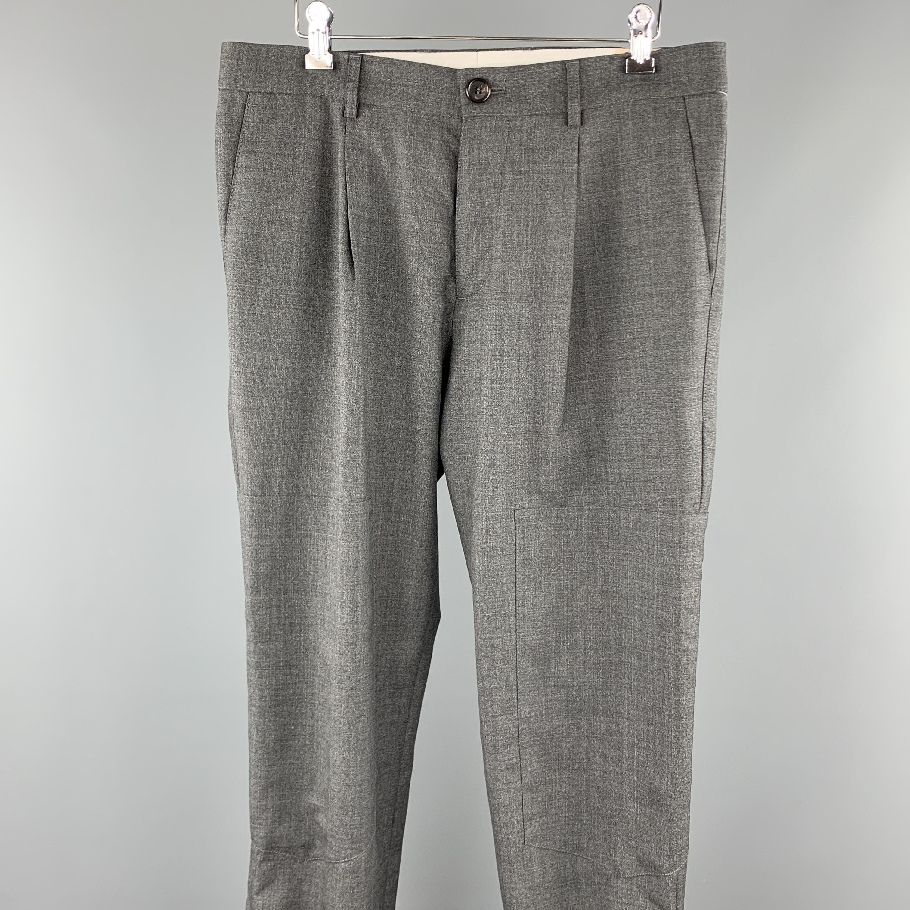 BRUNELLO CUCINELLI dress pants comes in a dark gray wool featuring a single pleat style, knee panels, elastic cuffs & zipper, and a zip fly closure. Made in Italy. 

Excellent Pre-Owned Condition.
Marked: IT 48

Measurements:

Waist: 34 in. 
Rise: