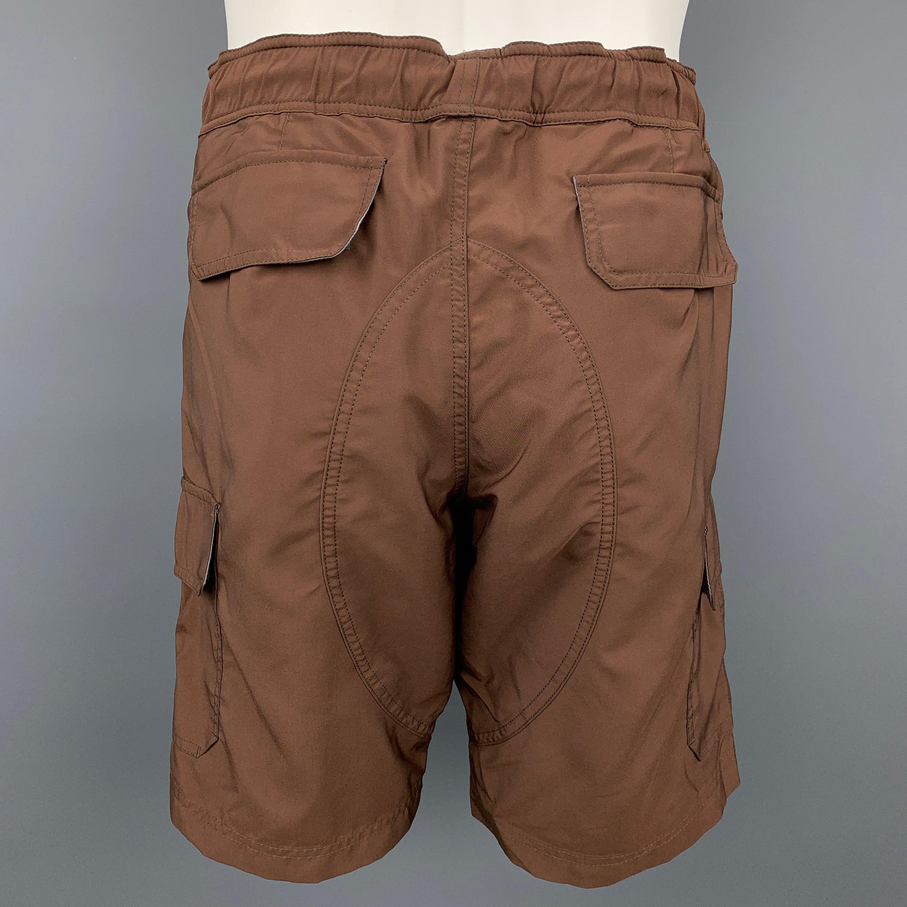 BRUNELLO CUCINELLI shorts comes in a brown polyester with a mesh liner featuring a cargo pockets, drawstring, zip fly, and a snap button closure. Made in Italy.New With Tags.  

Marked:   50 

Measurements: 
  Waist: 34 inches Rise: 11.5 inches 
