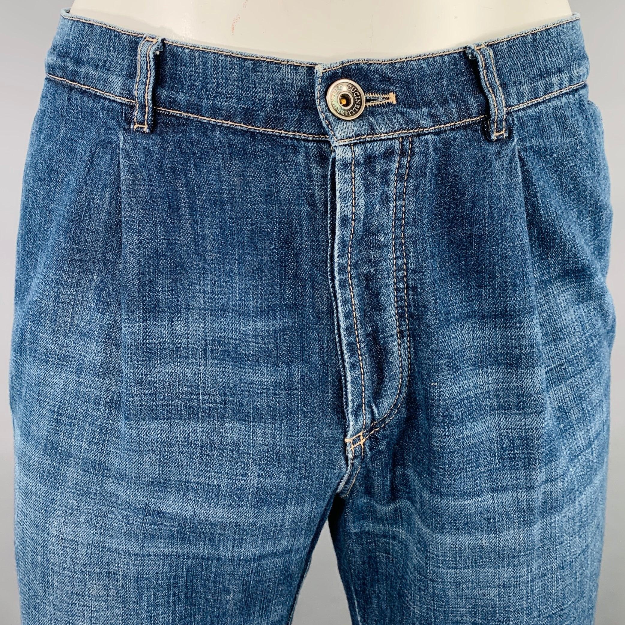 BRUNELLO CUCINELLI jeans
in an indigo denim featuring yellow contrast stitching, pleated design, straight leg, and button fly closure. Made in Italy.Very Good Pre-Owned Condition. Minor signs of wear. 

Marked:   size not marked 

Measurements: 
 