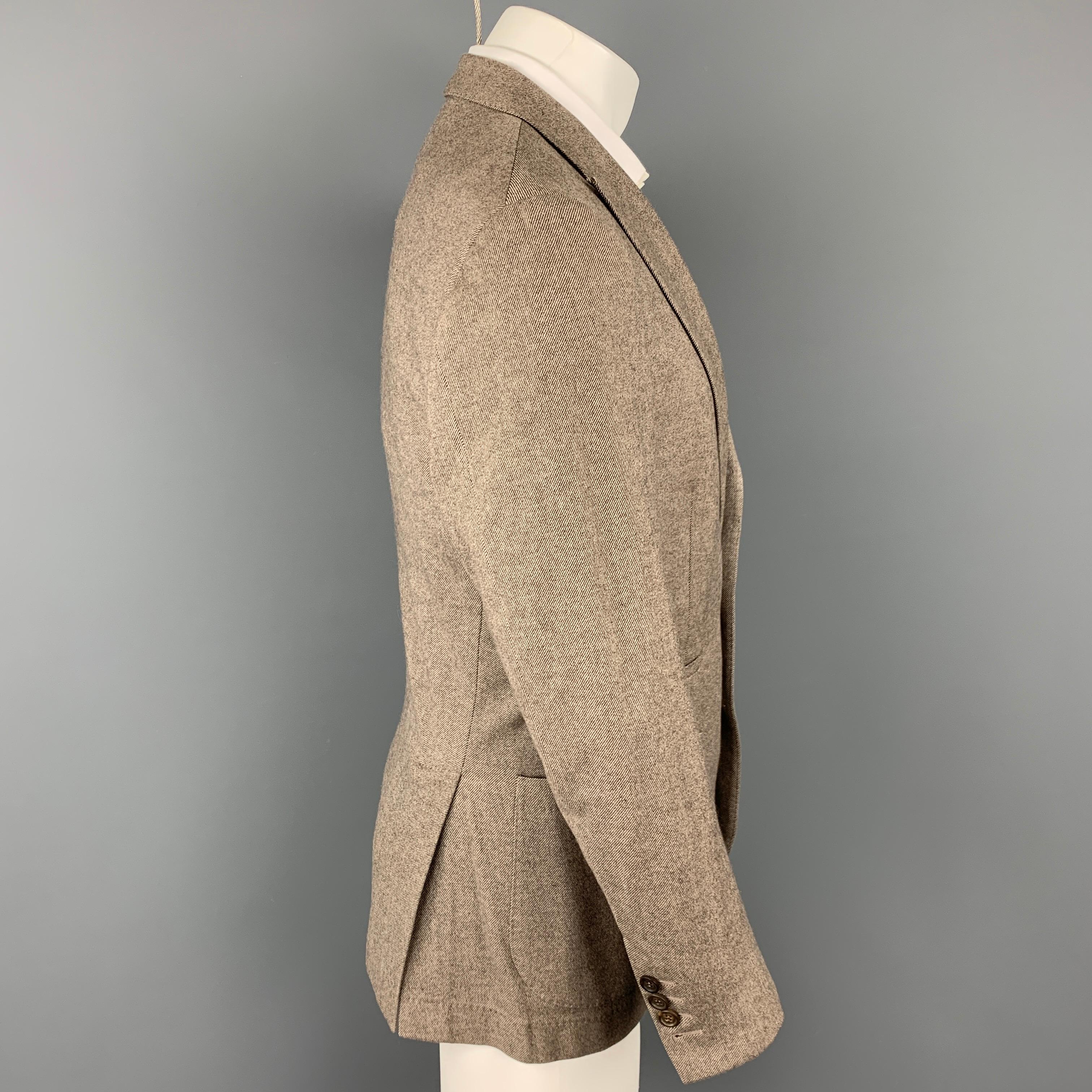 BRUNELLO CUCINELLI sport coat comes in a brown & cream twill material with a half liner featuring a peak lapel, patch pockets, and a three button closure. Comes with garment bag. Made in Italy.

Very Good Pre-Owned Condition.
Marked: