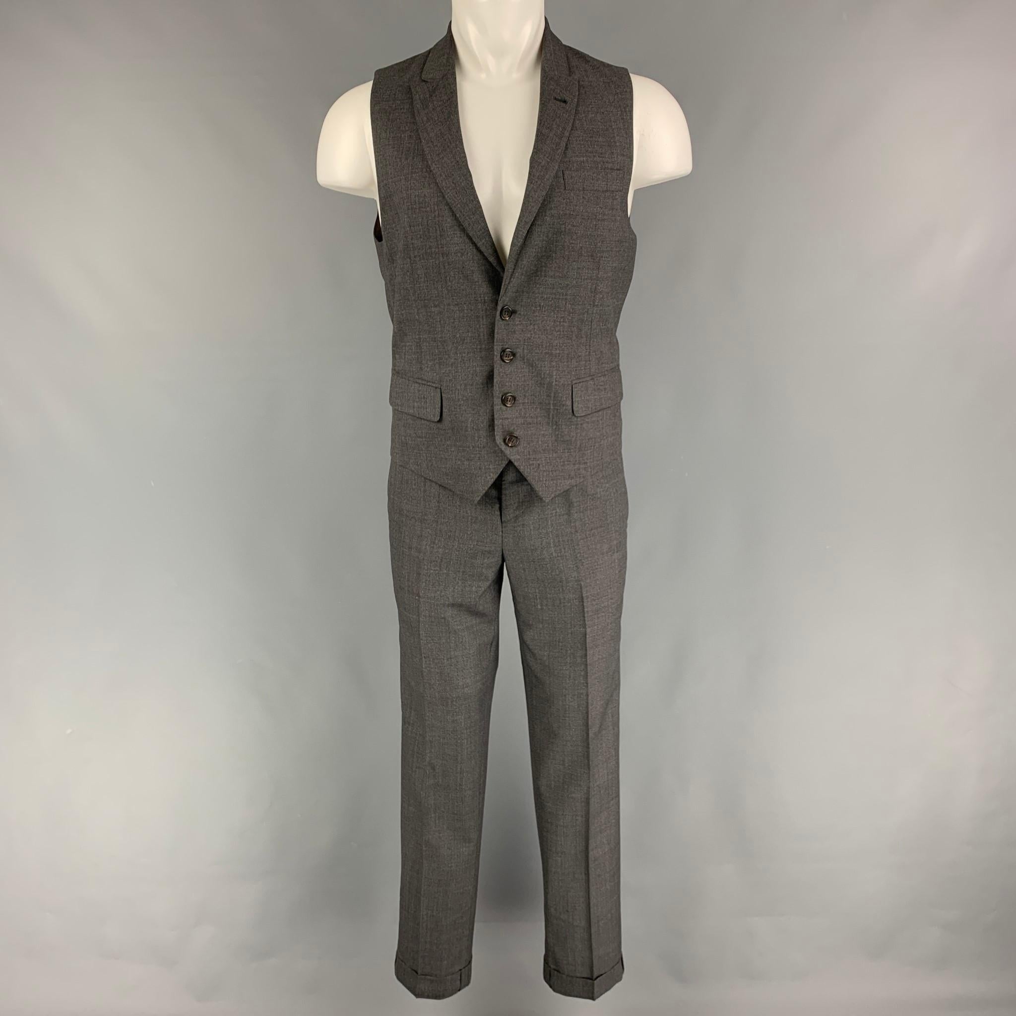 BRUNELLO CUCINELLI vest suit comes in a grey wool and includes a single breasted, four button dress vest with a peak lapel and matching flat front trousers. Made in Italy.

Very Good Pre-Owned Condition.
Marked: Pants /