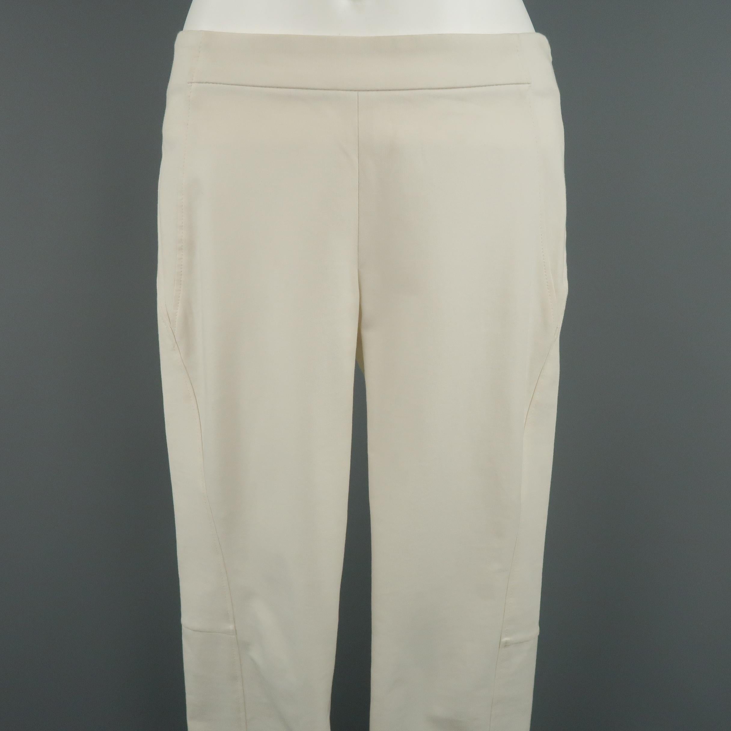 BRUNELLO CUCINELLI legging pants come in off white stretch twill with motorcycle details.  Made in Italy.
 
Very Good Pre-Owned Condition.
Marked: 4
 
Measurements:
 
Waist: 30 in.
Rise: 8 in.
Inseam:  29 in.