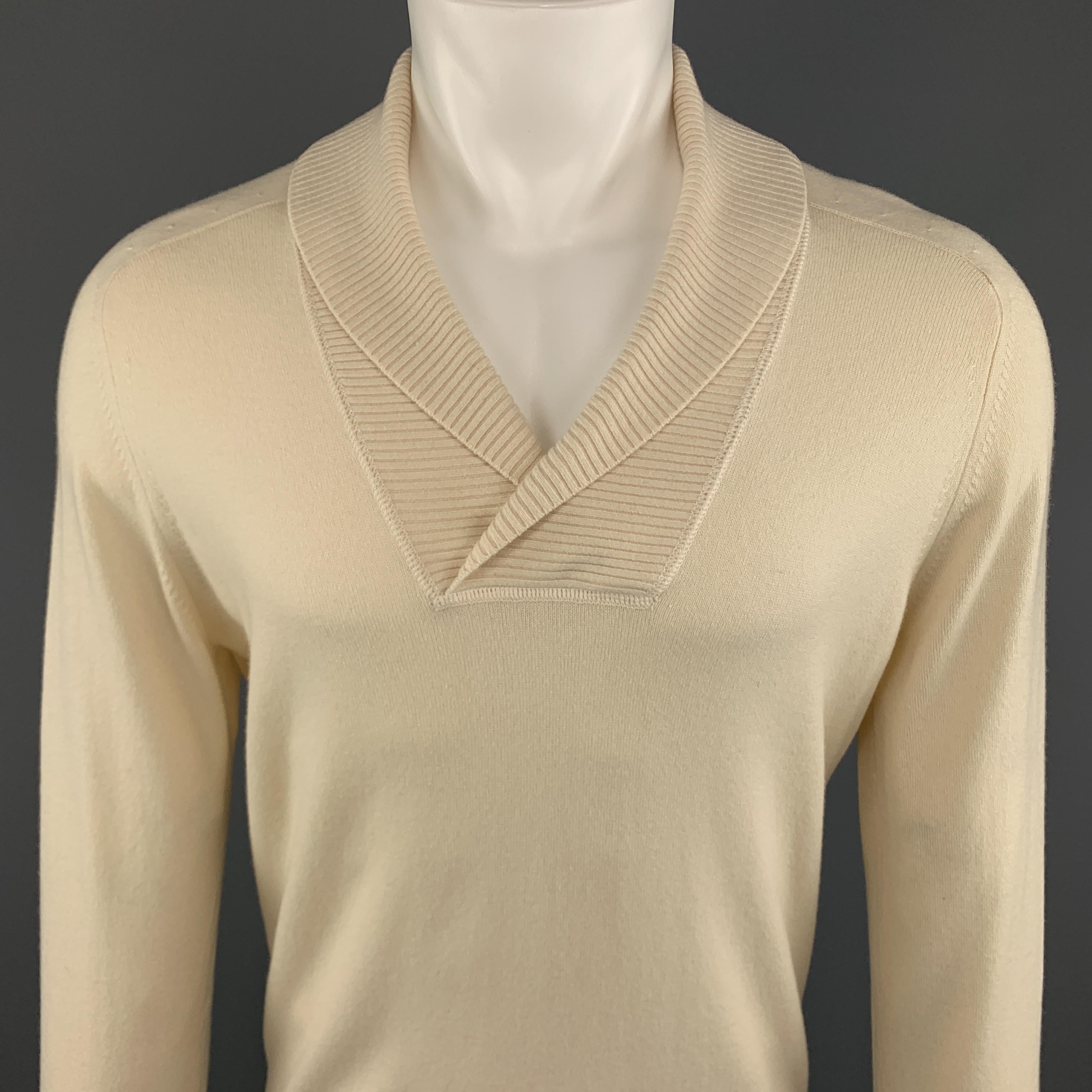 BRUNELLO CUCINELLI Pullover Sweater comes in a cream tone in a solid cashmere material, with a shawl collar, raglan long sleeves and ribbed cuffs and hem. Made in Italy.
 
New With Tags.
Marked: IT 50
 
Measurements:
 
Shoulder: 17.5 in.
Chest: 42
