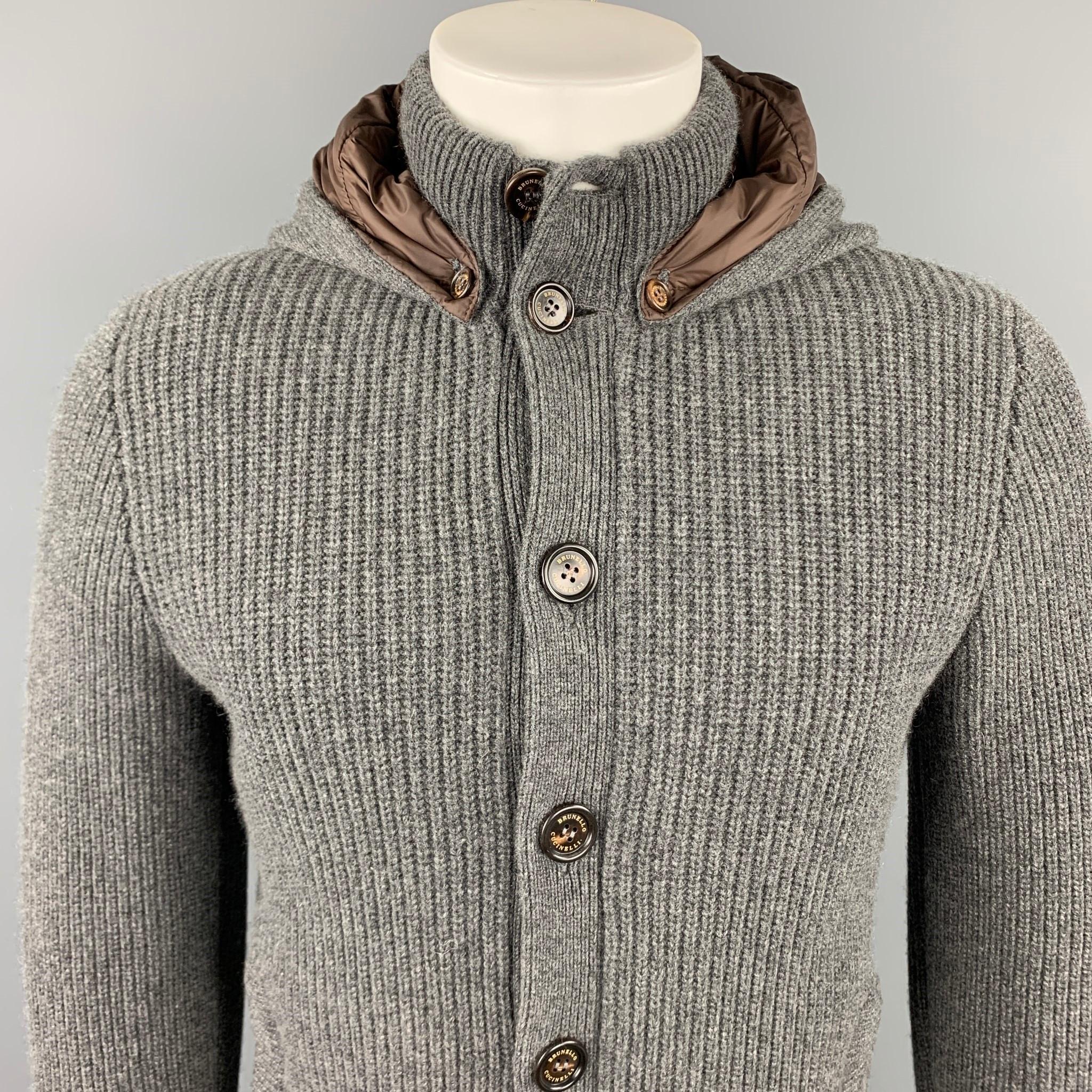 BRUNELLO CUCINELLI jacket comes in a dark gray knitted cashmere featuring a detachable hood, slit pockets, and a buttoned closure. Made in Italy.

Very Good Pre-Owned Condition.
Marked: IT 50

Measurements:

Shoulder: 17.5 in.
Chest: 38 in.
Sleeve: