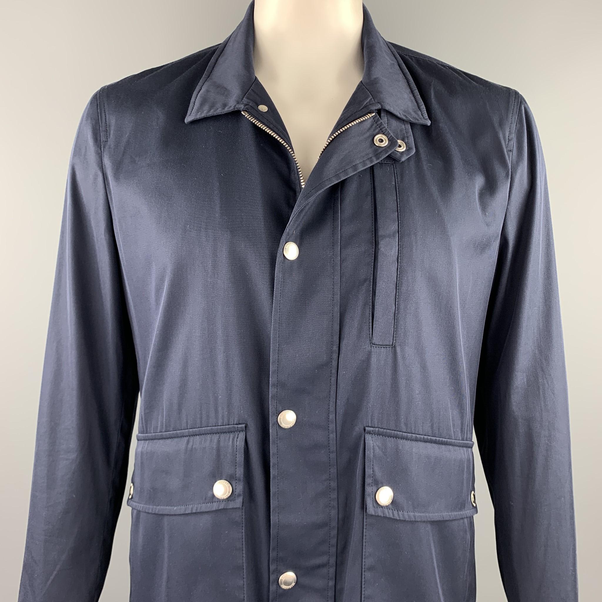 BRUNELLO CUCINELLI jacket comes in a navy cotton blend with a half liner featuring patch pockets, double vent, collar strap detail, and a snap button closure. Made in Italy.

New With Tags. 
Marked: IT 52
Original Retail Price: