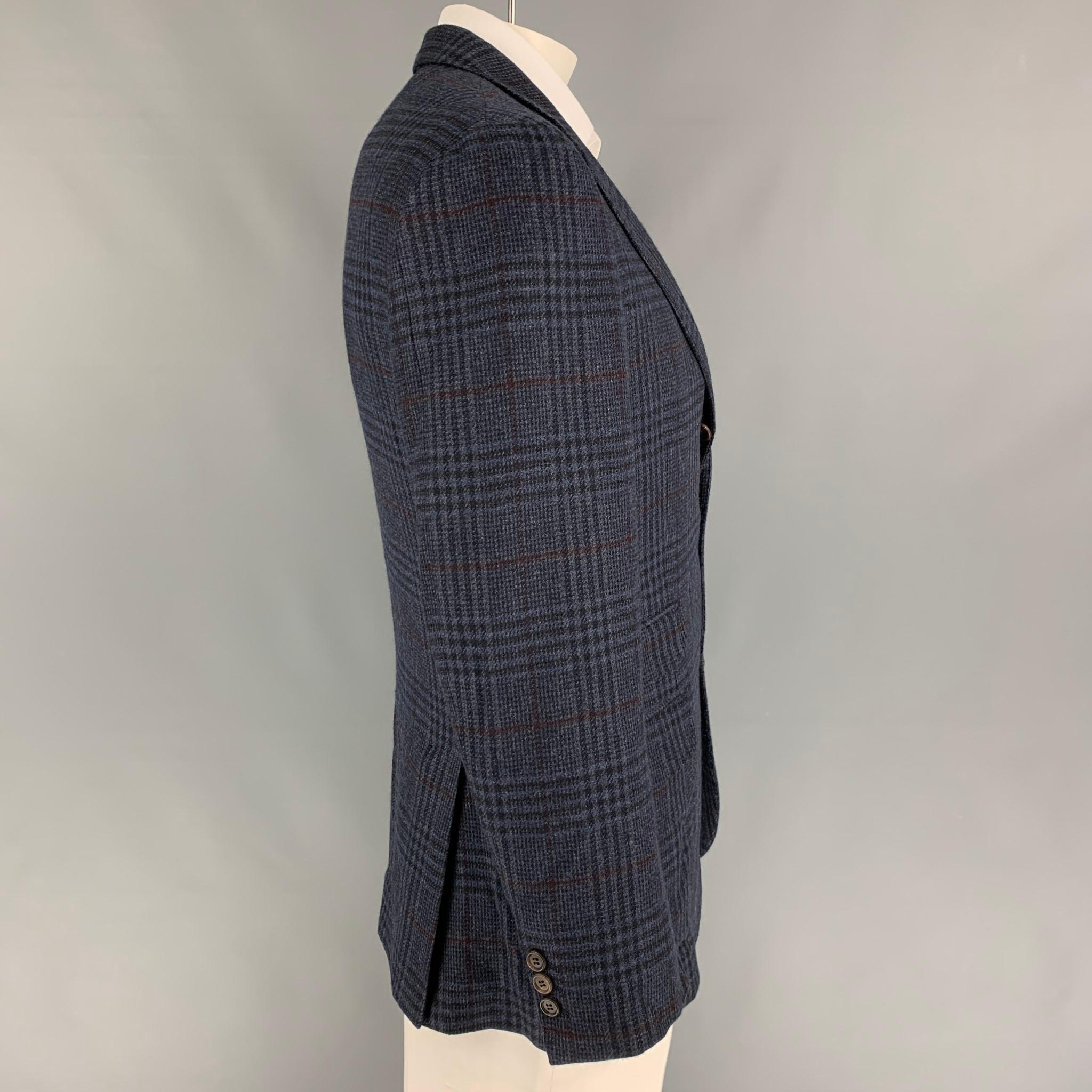 BRUNELLO CUCINELLI sport coat comes in a navy & gray plaid cashmere with a full liner featuring a notch lapel, flap pockets, double back vent, and a three button closure. Made in Italy. 

Very Good Pre-Owned Condition.
Marked: