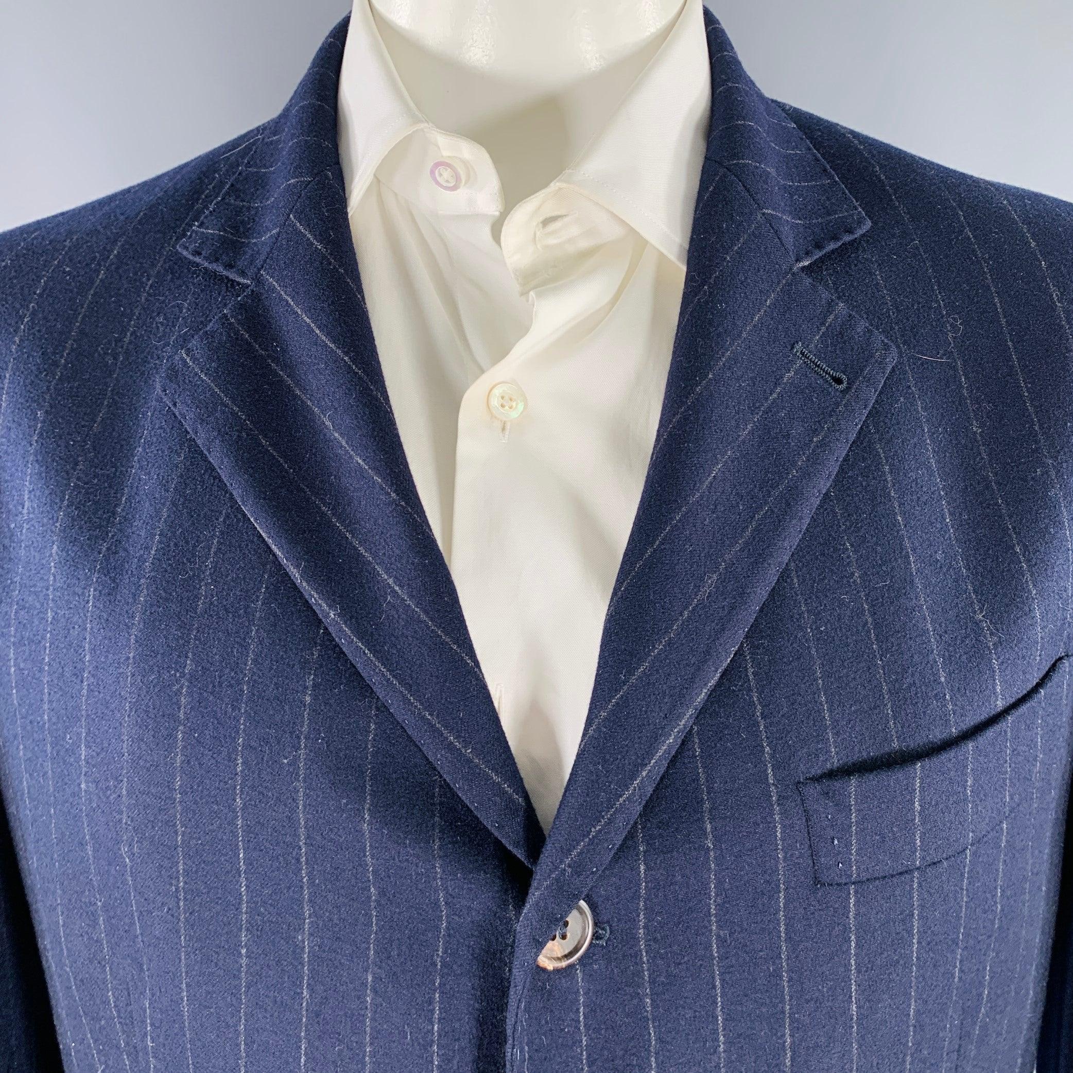 BRUNELLO CUCINELLI sport coat
in a navy and grey wool cashmere blend fabric featuring a pinstripe pattern, tan suede elbow patches, notch lapel, double vented back, and double button closure. Made in Italy.Very Good Pre-Owned Condition. Marks on