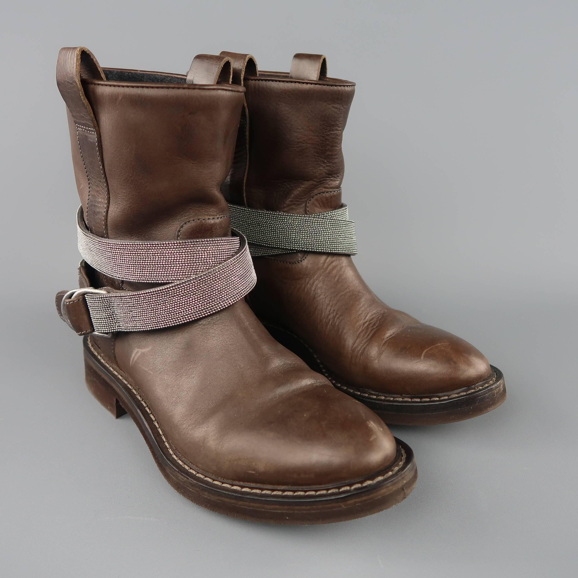 BRUNELLO CUCINELLI biker style boots come in chocolate brown leather with a pointed toe, thick rubber heeled sole, and wrapped ankle strap with Monoli sparkle beading. With dust bags. Scuffs throughout. As-is. Made in Italy.
 
Fair Pre-Owned