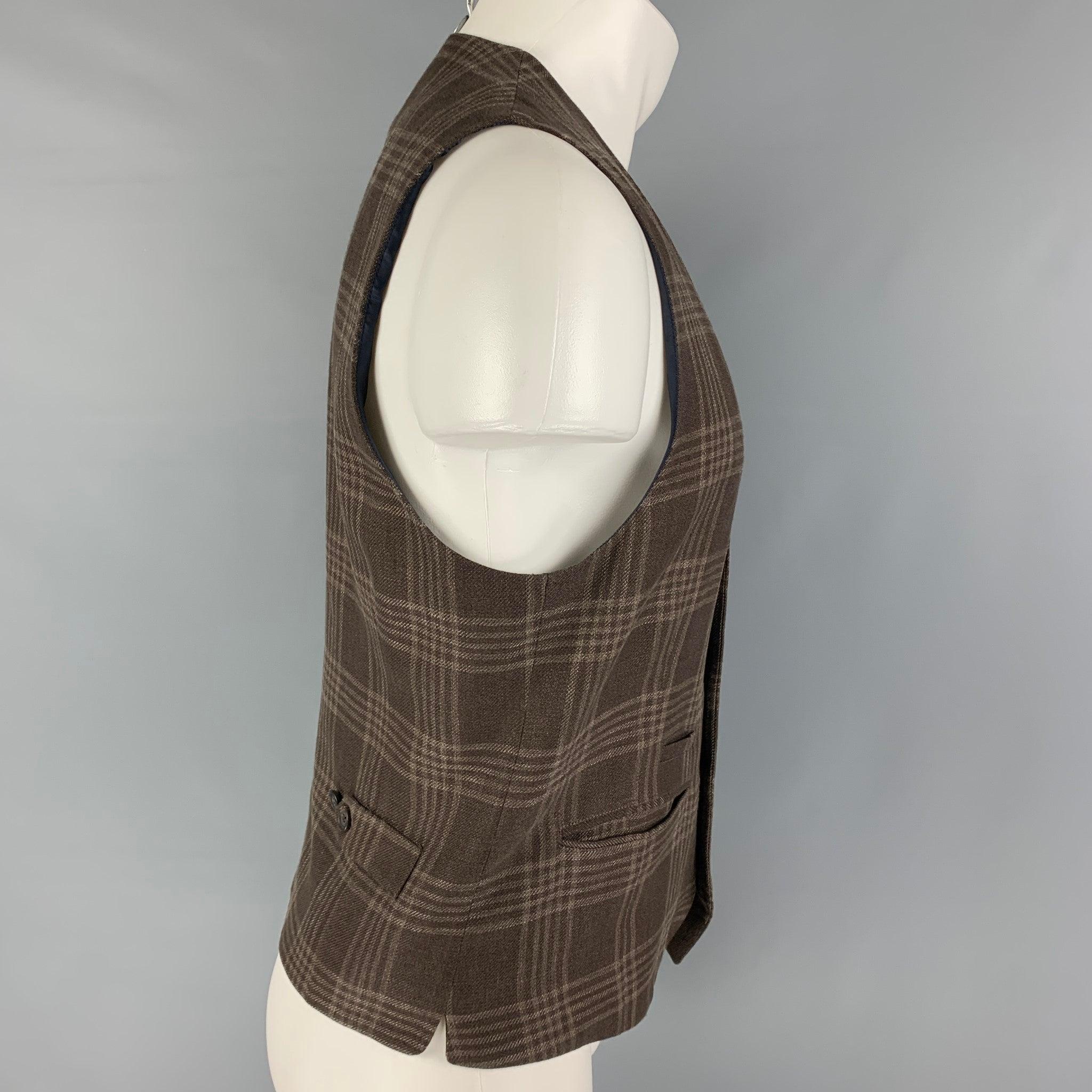 BRUNELLO CUCINELLI vest comes in a brown plaid linen blend featuring slit pocket, side tabs, and a buttoned closure. Made in Italy.
Excellent
Pre-Owned Condition. 

Marked:   50 

Measurements: 
 
Shoulder: 14 inches Chest: 38 inches Length: 23