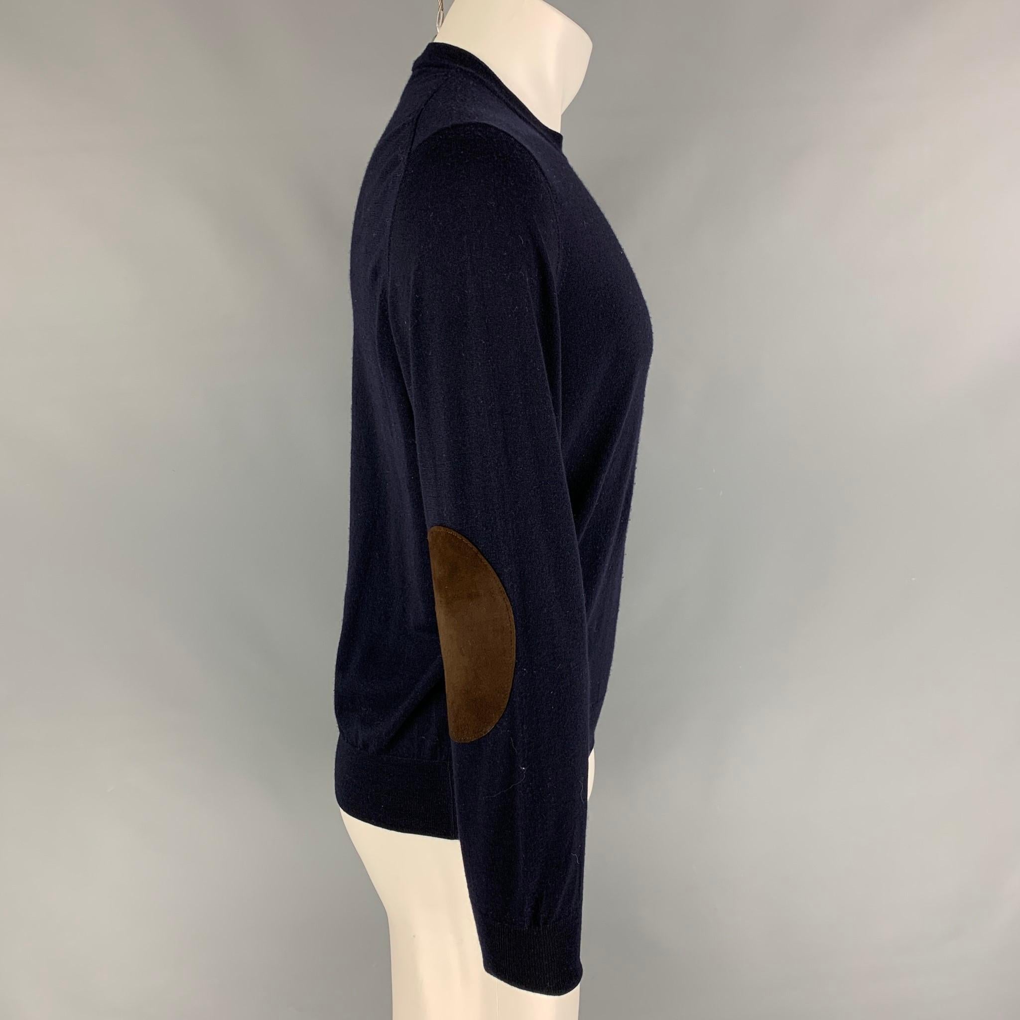 BRUNELLO CUCINELLI pullover comes in a navy wool / cashmere featuring brown suede elbow patches and a crew-neck. Made in Italy. 

Good Pre-Owned Condition.
Marked: 48

Measurements:

Shoulder: 17.5 in.
Chest: 38 in.
Sleeve: 27 in.
Length: 25 in. 