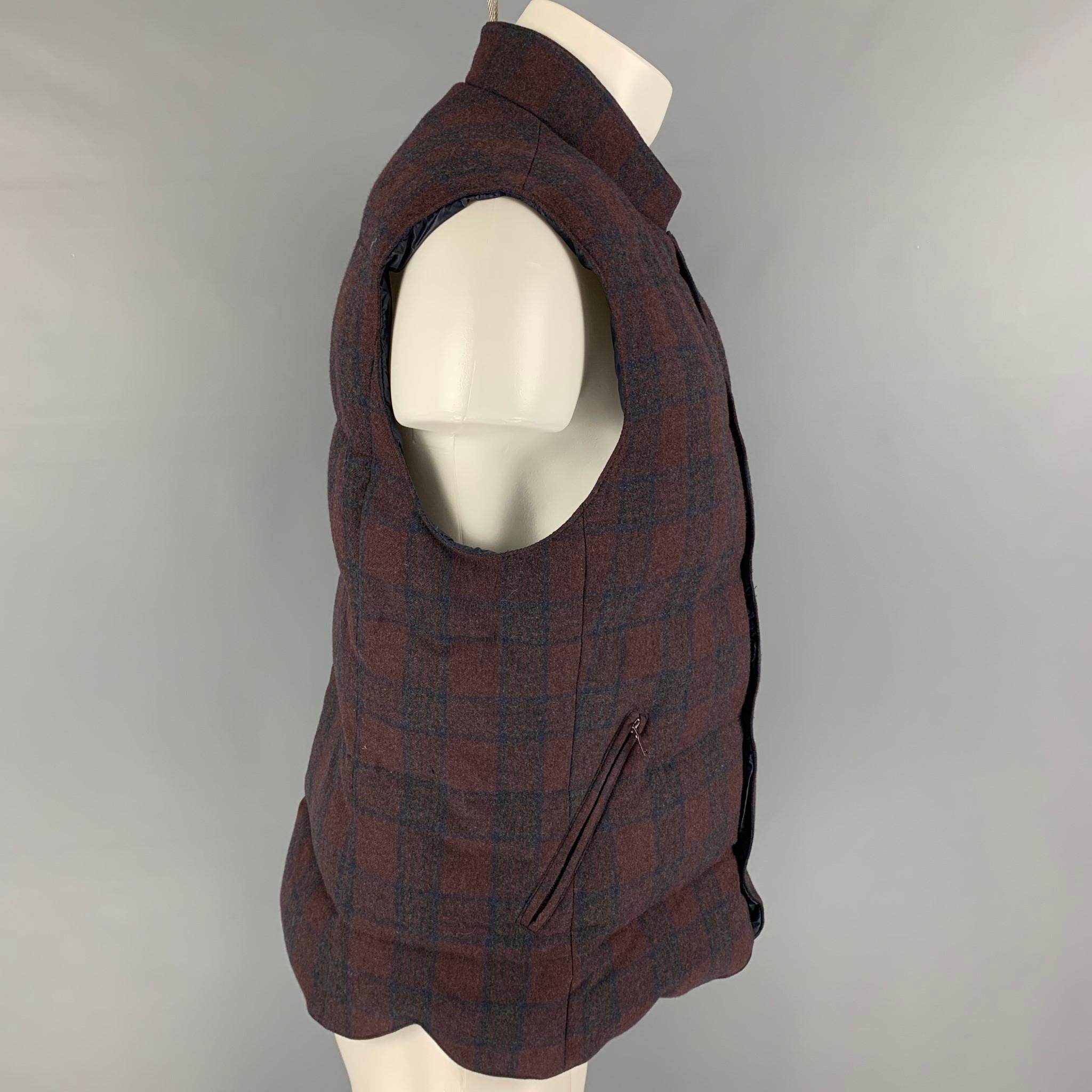BRUNELLO CUCINELLI vest comes in a brown & burgundy plaid wool blend featuring a stand up collar, zipper pockets, and a snap button closure. Made in Italy. 

Excellent Pre-Owned Condition.
Marked: M

Measurements:

Shoulder: 18 in.
Chest: 42
