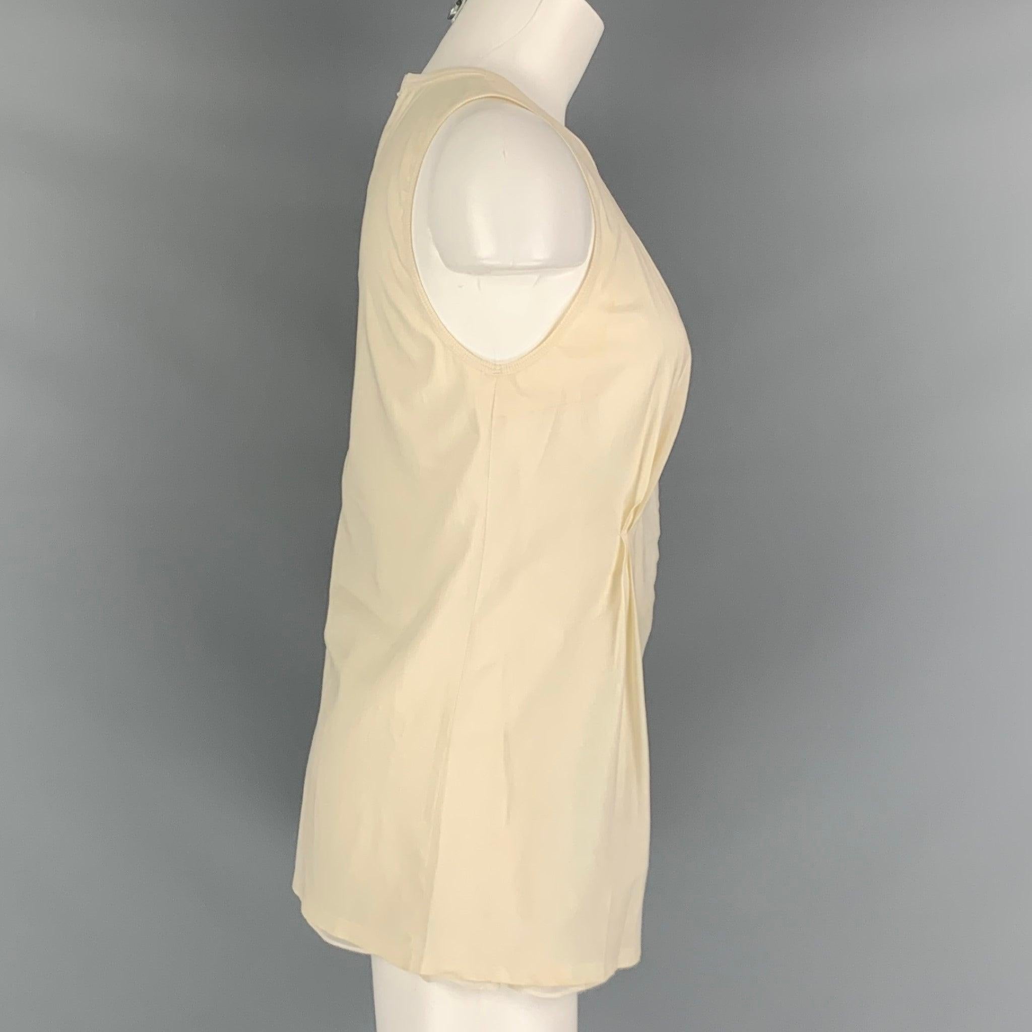 BRUNELLO CUCINELLI tank top comes in a cream woven material featuring an embroidered detail, and three rhinestones. Made in Italy.Good Pre-Owned Condition. Moderate marks throughout. As-Is. 

Marked:   L 

Measurements: 
  Bust: 32 inches Length: 27