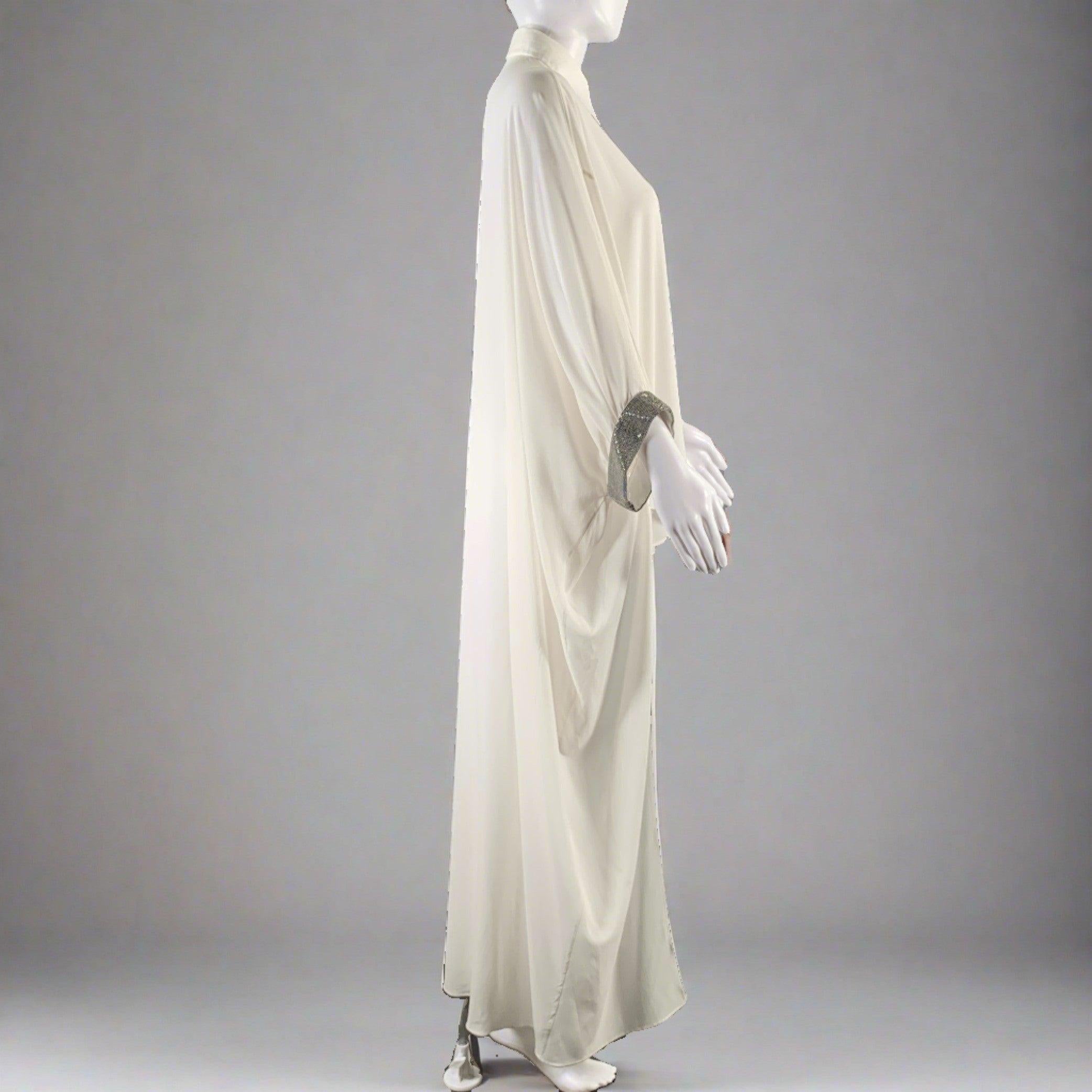 BRUNELLO CUCINELLI 3/4 sleeve dress top comes in a white silk and elastane woven material featuring a caftan style, loose fit, monili embellishment at cuffs,
 spread collar, and a buttoned closure. Made in Italy. Very Good Pre-Owned Condition. Signs