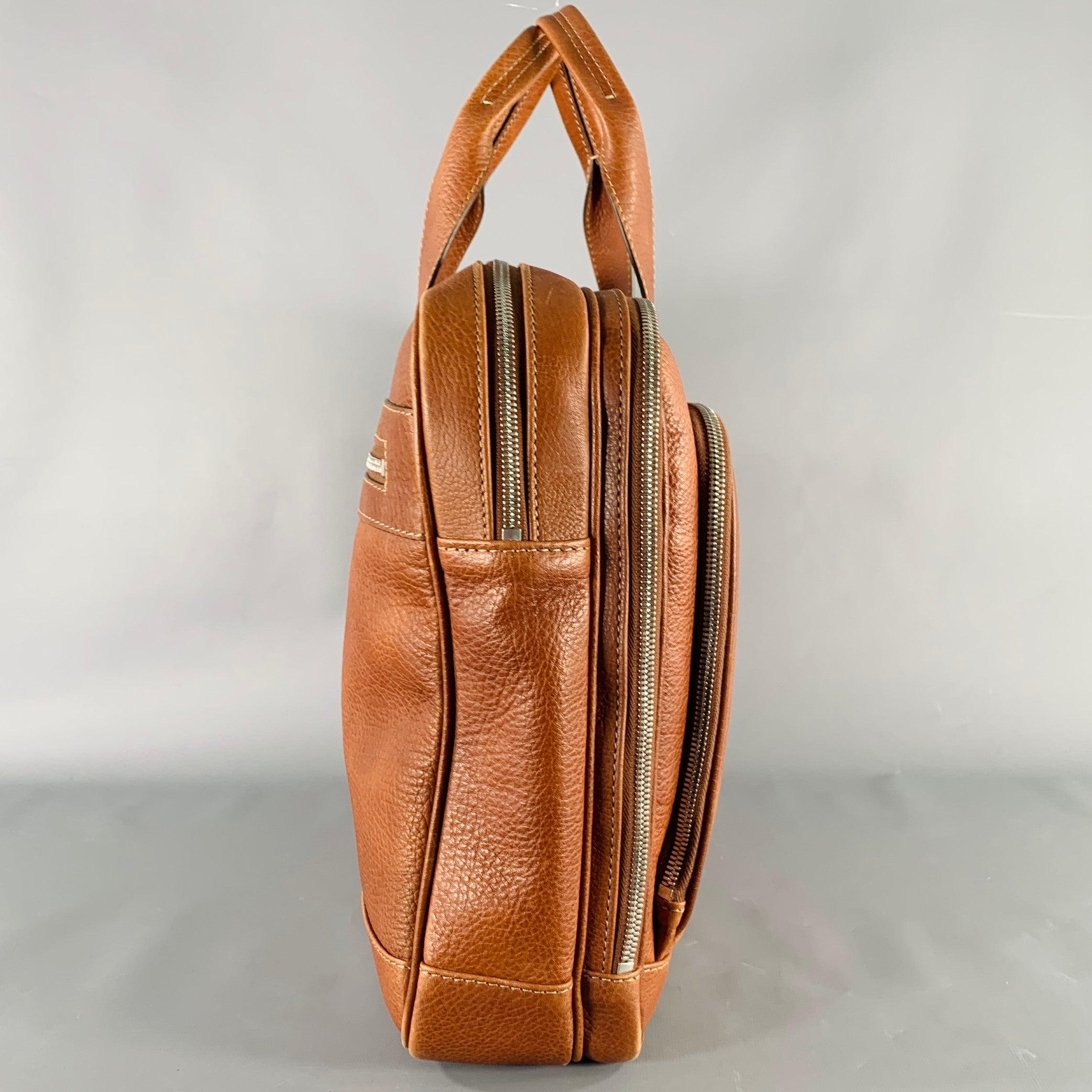 BRUNELLO CUCINELLI briefcase
in a tan leather featuring multiple spacious compartments with holders for cards and pens, and silver tone metal zip closures. Made in Italy.Very Good Pre-Owned Condition. Signs of wear on bottom corners. 

Measurements: