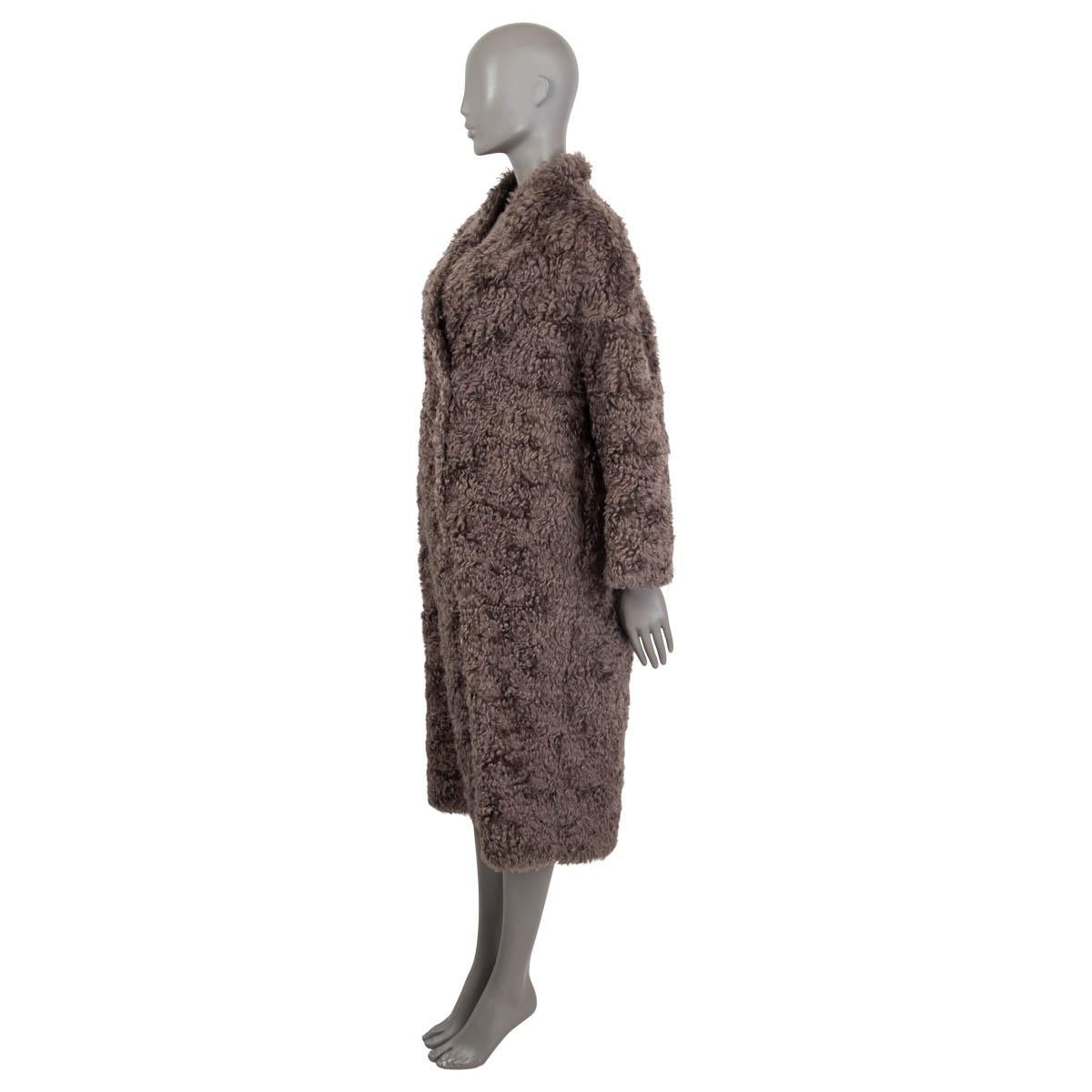 100% authentic Brunello Cucinelli faux shearling coat in gray mohair (74%) and cotton (26%). Features long sleeves and two slit pockets on the side. Opens with four concealed buttons on the front. Pockets lined in gray acetate (74%) and silk (26%).