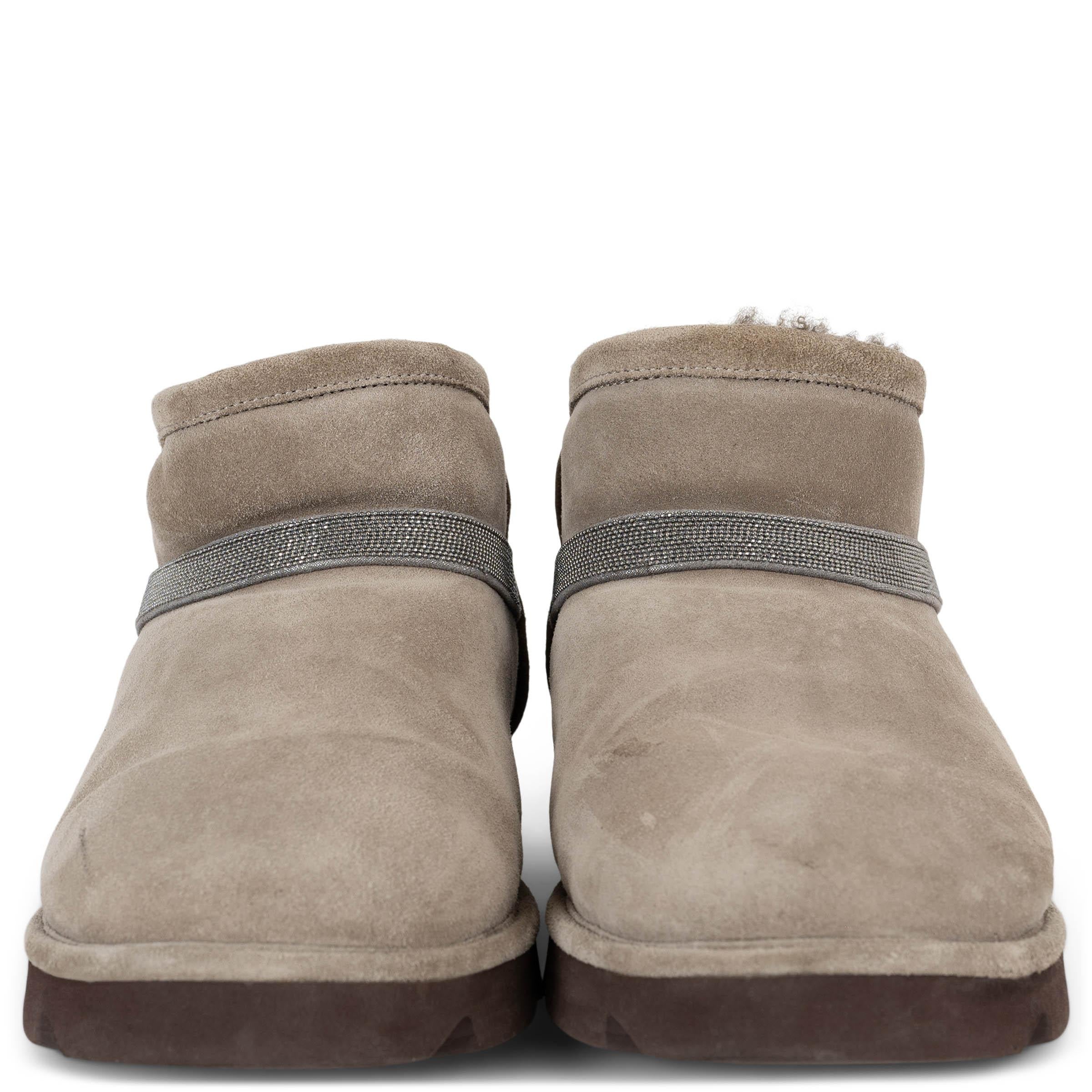 This 100% authentic Brunello Cucinelli boots in light taupe suede combine refined craftsmanship with cozy sophistication. Designed with rounded toes and a plush dark shearling lining for warmth, they feature a signature Monili strap for a touch of