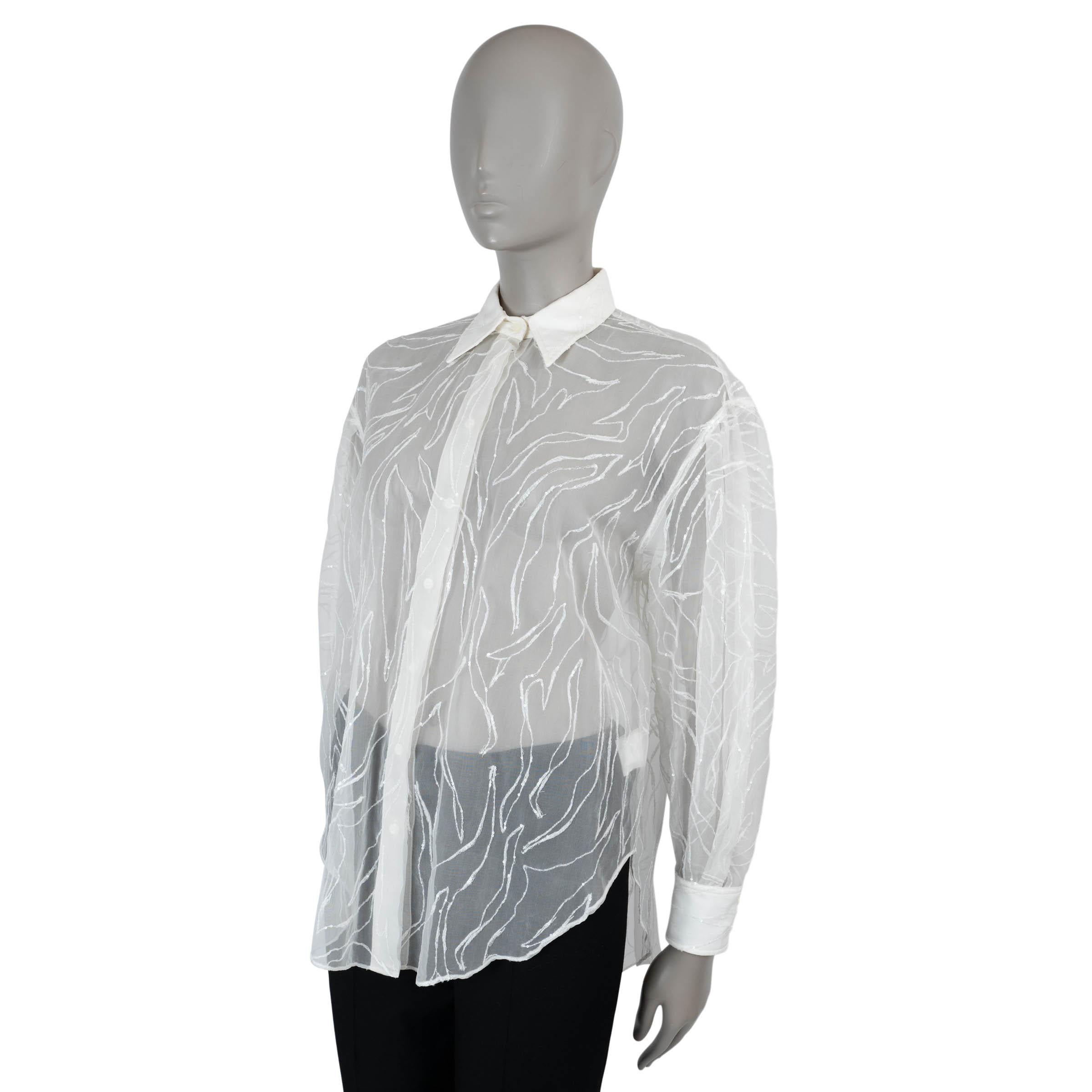 This 100% authentic Brunello Cucinelli shirt in cream sheer silk (100%) exudes refined elegance with a touch of sparkle. Adorned with delicate sequin-embellished embroidery throughout, it features a relaxed silhouette with a curved hem for graceful