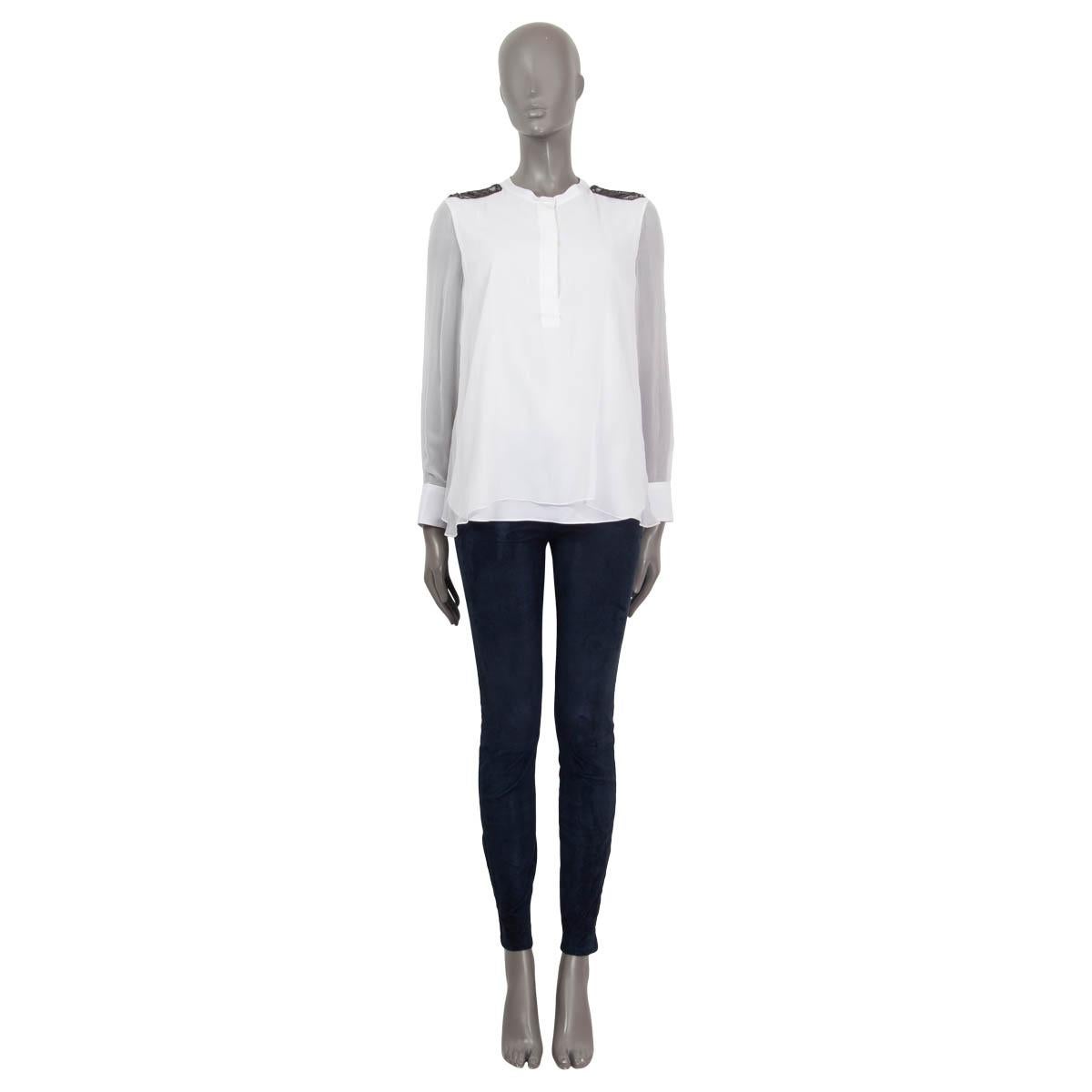 100% authentic Brunello Cucinelli semi sheer blouse in white silk (100%). Features crystal and pearl embroideries on the shoulders and buttoned cuffs. Opens with three concealed buttons on the front. Lined in white silk (92%) and elastane (8%). Has