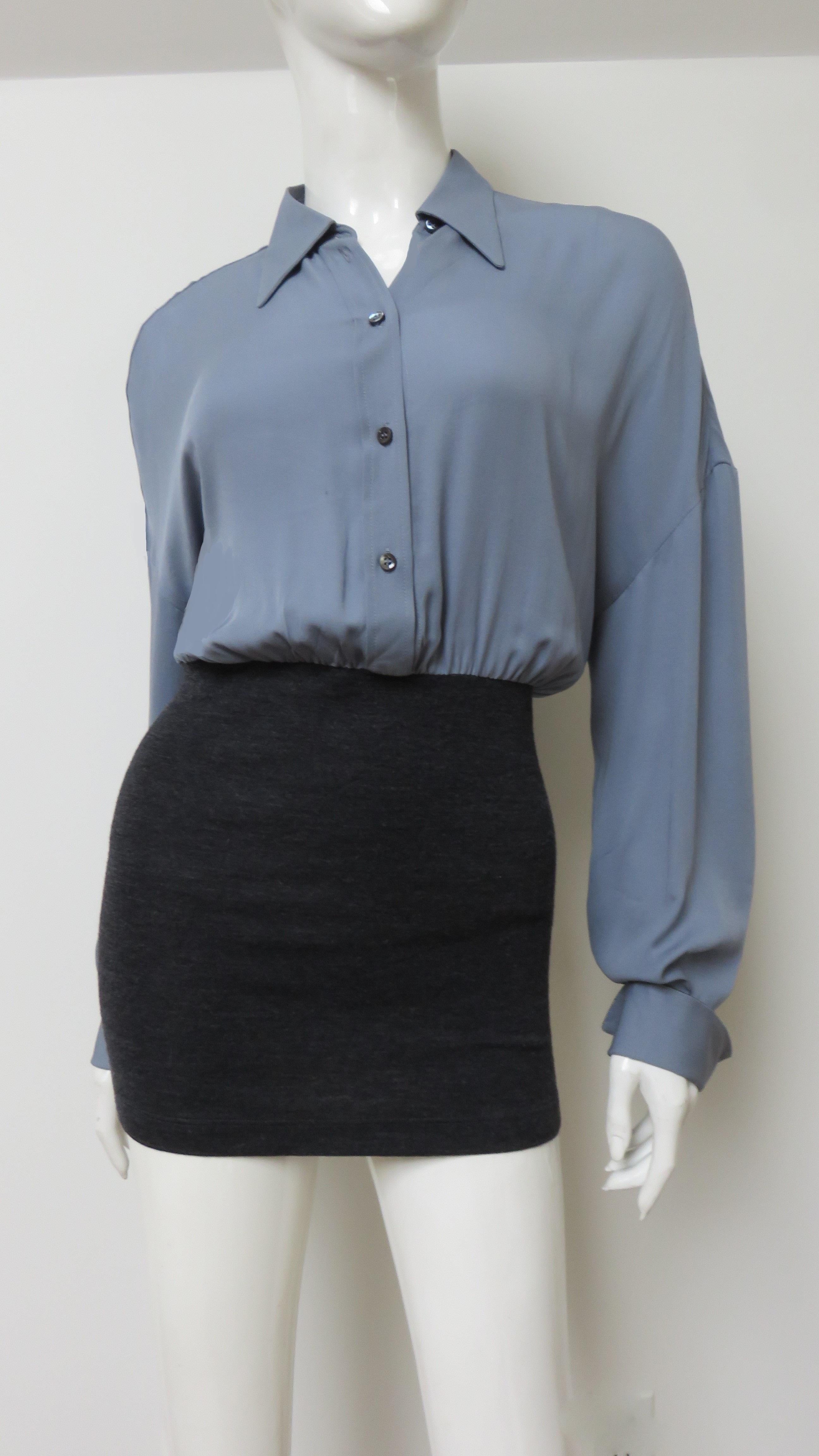 A beautiful grey silk and charcoal wool shirt by Bruno Cucinelli.  The upper half is grey silk with a shirt collar, mother of pearl button front closing and long sleeves with button fold back cuffs outlined in Cucinelli's signature delicate beading.