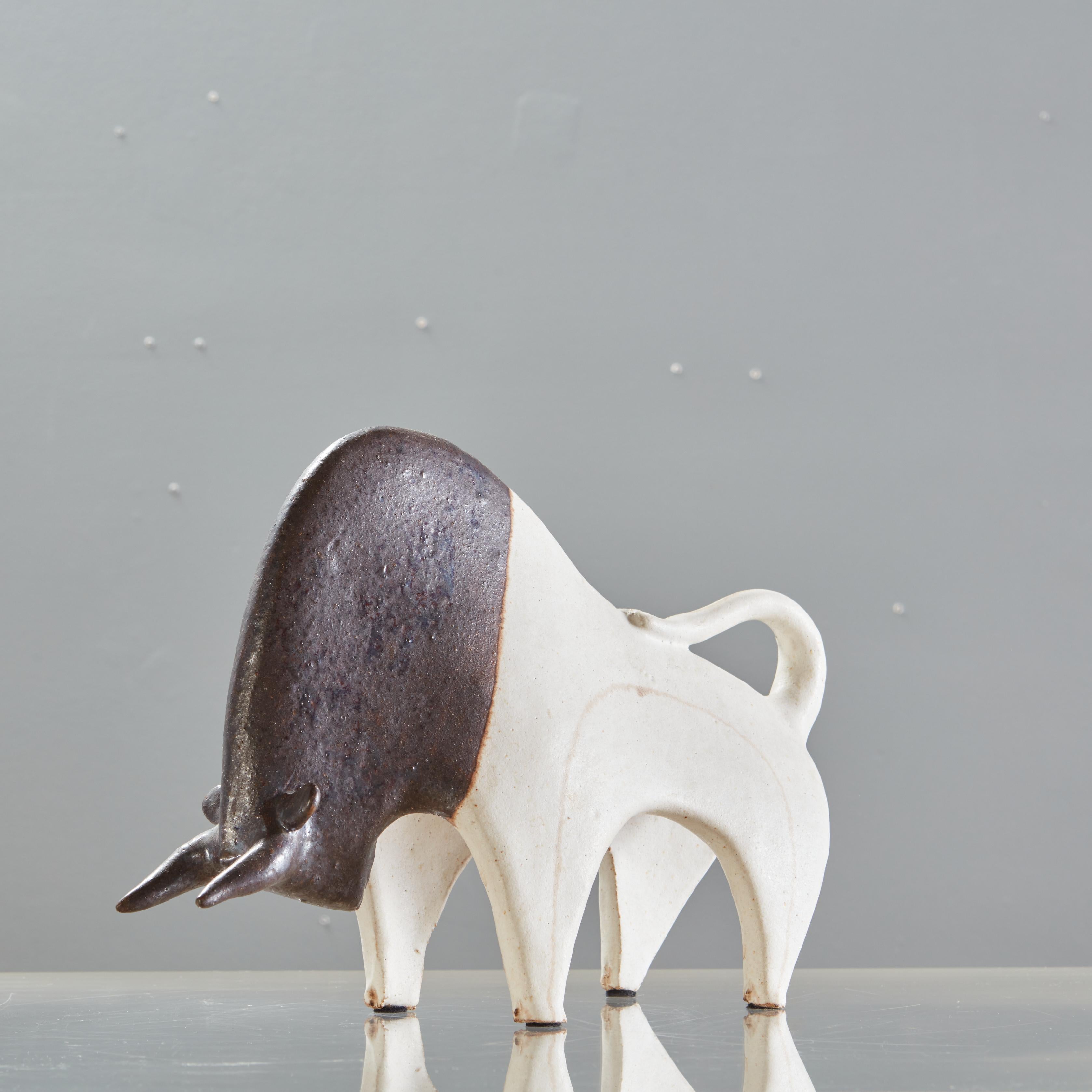 A sublime pair of signed Bruno Gambone Bull sculptures in matte cream and brown glaze.

Dimensions of sm bull: 4.5h x 6.5