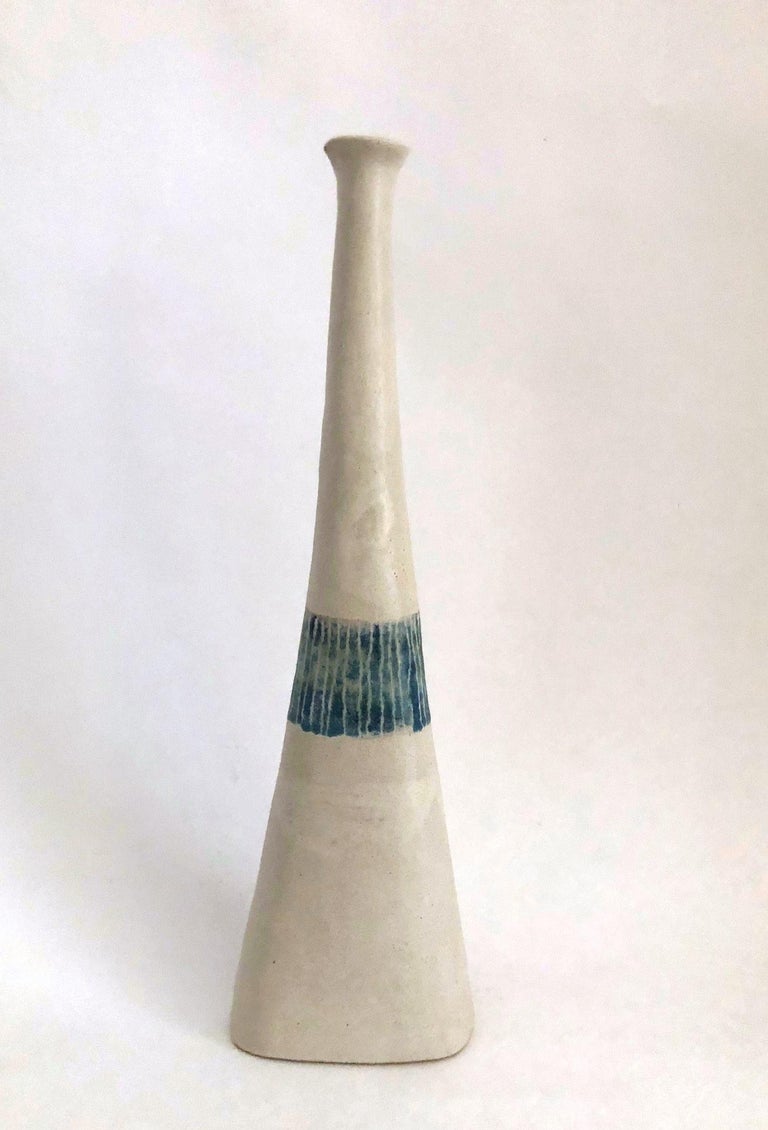 Stoneware vase with blue line decoration on off-white matte glaze.
Artist-signed Gambone Italy at base.

About the artist:
Bruno Gambone (born in 1936) is an Italian ceramist and the son of Guido Gambone, one of Italy's most prominent ceramists