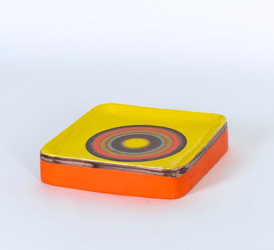 Stoneware with shiny yellow and colored circles, can be used as tray or wall decoration
Artist-signed Gambone Italy at base.

About the artist:
Bruno Gambone (born in 1936) is an Italian ceramist and the son of Guido Gambone, one of Italy's most