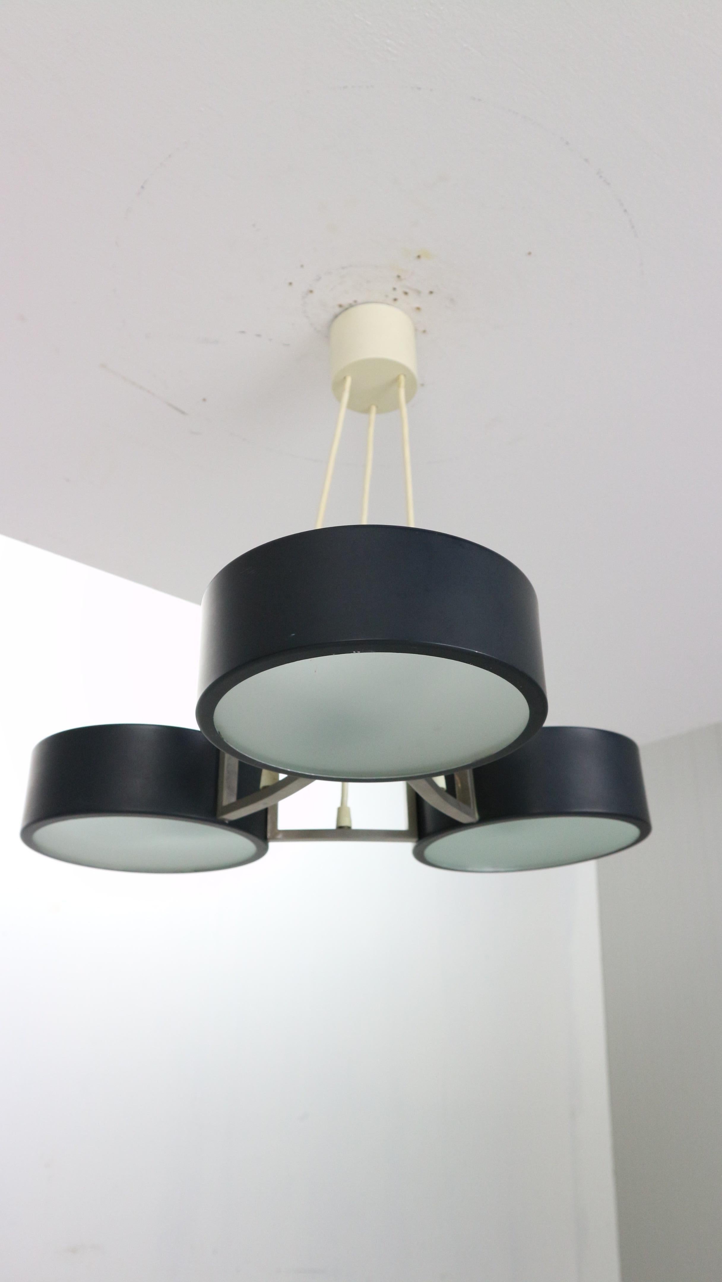 Chandelier/ pendant designed by Bruno Gatta and manufactured for Stilnovo in 1960s period, Italy.
This lamp has three black lacquered metal shades with milk glass opaline glass diffuser shades, which is held by elegant nickel fixture.
Lamp has