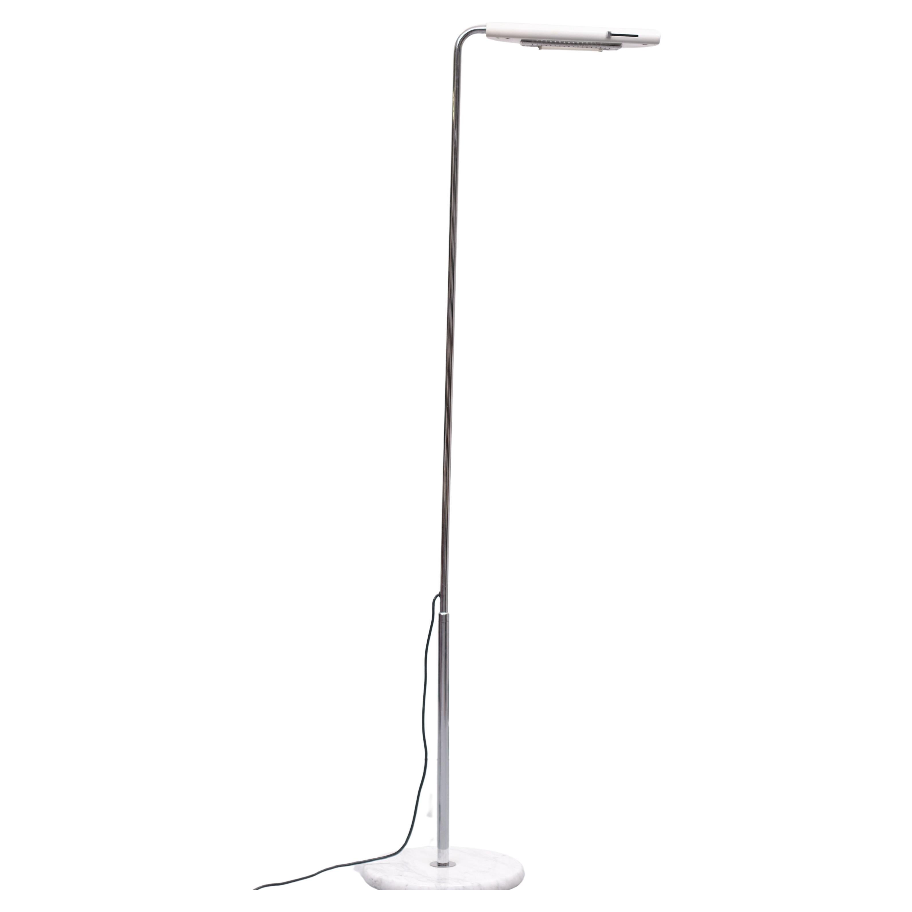 This Italian floor lamp, model Mezzaluna, was designed by Bruno Gecchelin in 1974 and produced by Skipper and Pollux in Milano. The floor lamp has a chrome-plated tubular steel structure, a white marble base, and White -enameled adjustable head. The