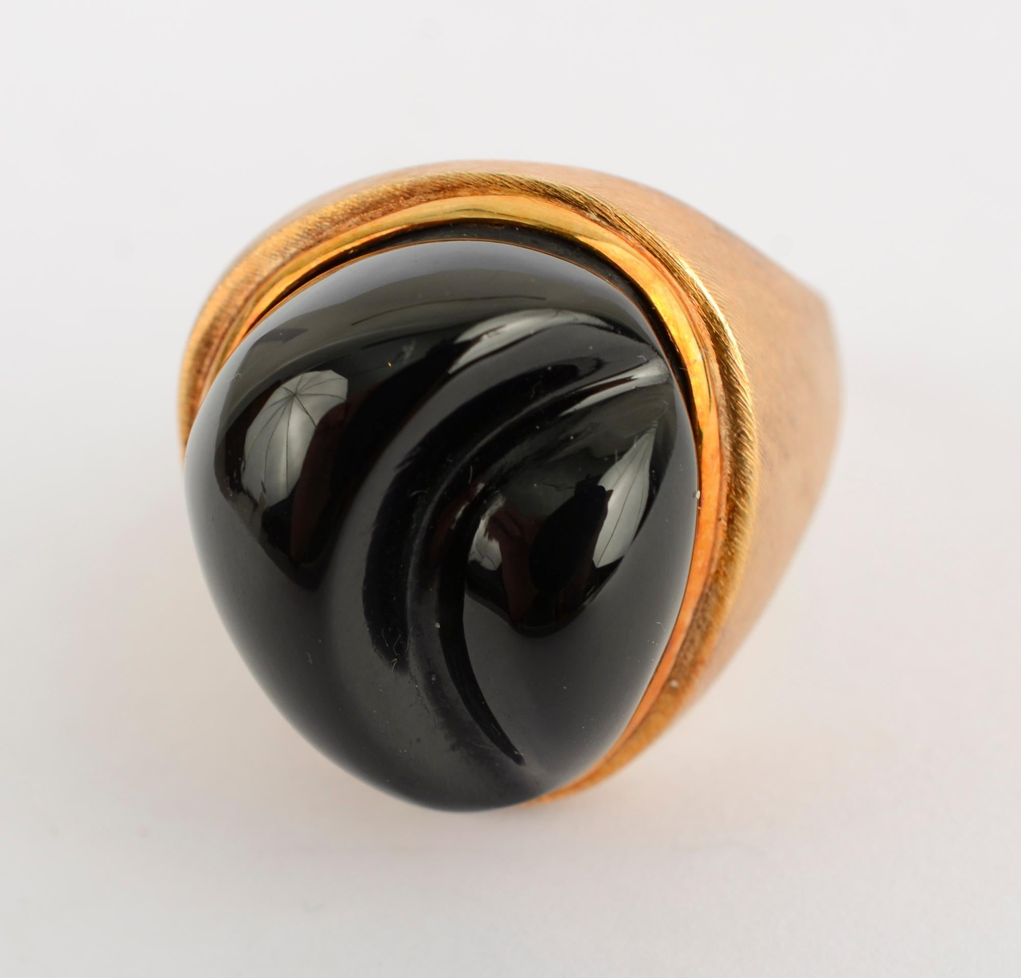 This ring was made by  Bruno Guidi, head designer and chief goldsmith for the acclaimed Brazilian jeweler Haroldo Burle Marx. They worked together for more than 30 years.  The forma livre black tourmaline stone is typical of their work.
The gold has