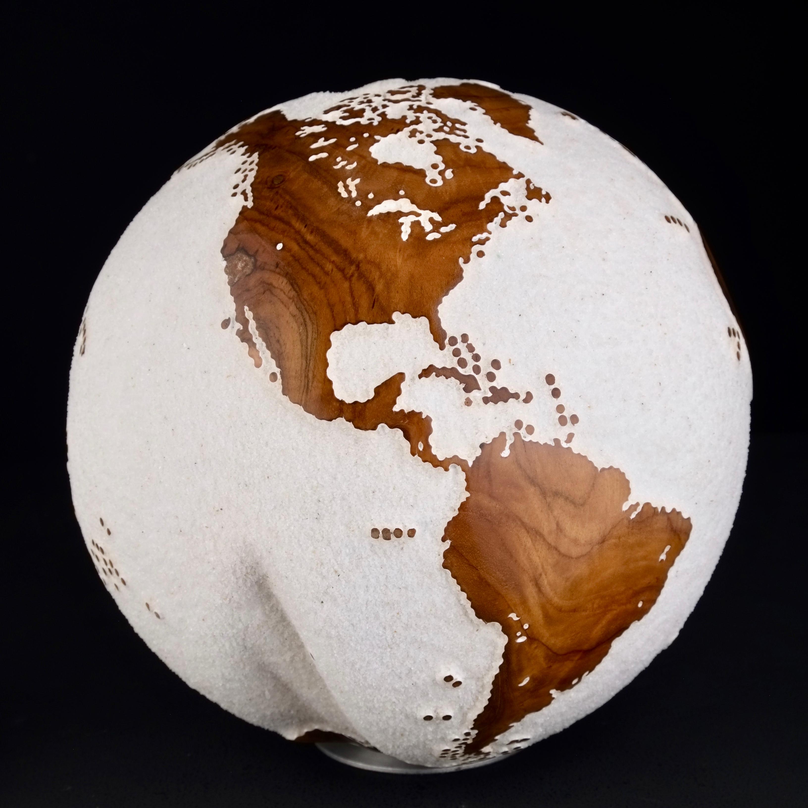 Teakwood and white lava sand make this beautiful turning globe a real stunning sculpture.
Made from a whole piece of wood the way the sculpture is shaped is defined by how the tree grew.
Sitting on a turning base the sculpture can spin silently