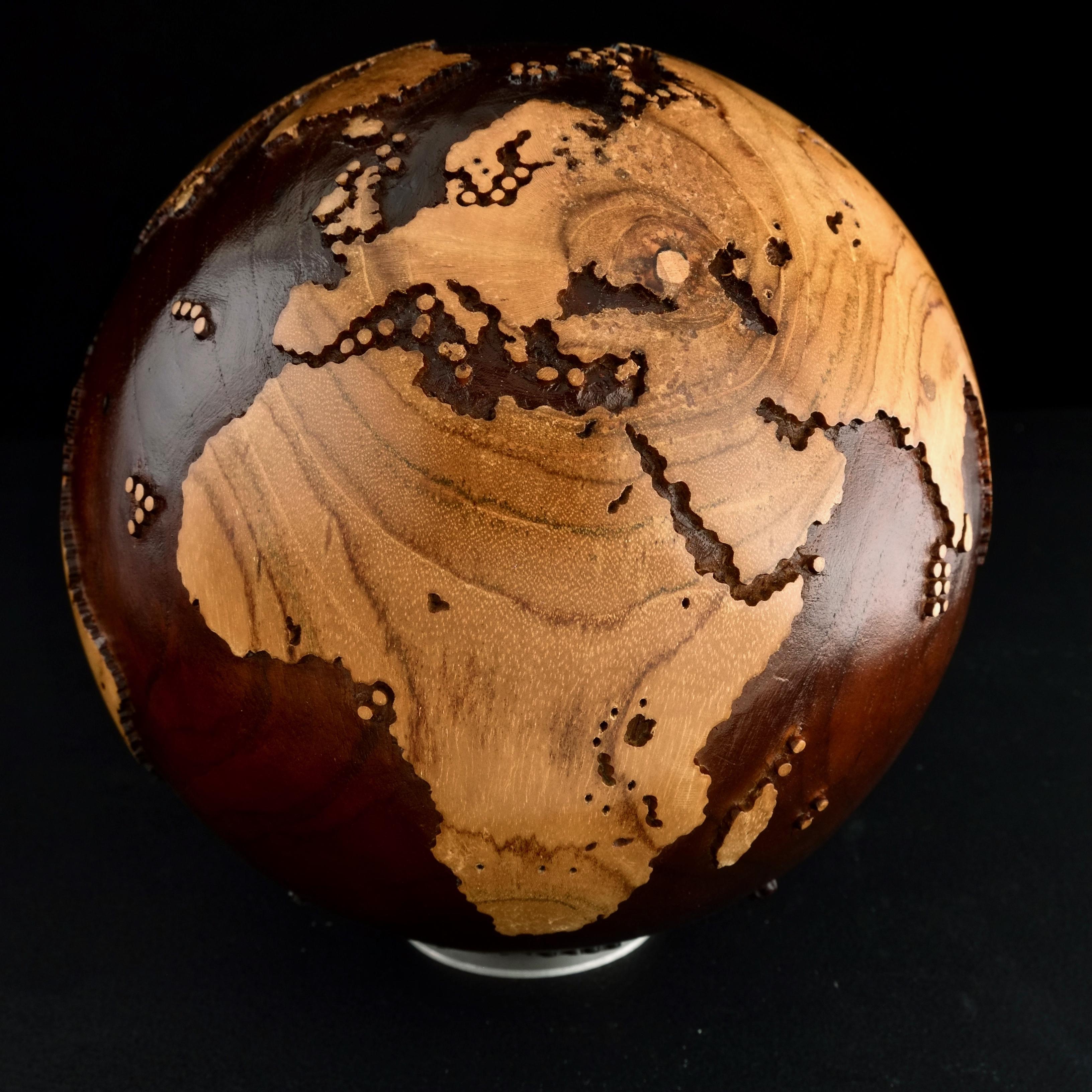 Walnut stain makes this beautiful turning globe a real stunning sculpture.
Made from a whole piece of wood the way the sculpture is shaped is defined by how the tree grew.
Sitting on a turning base the sculpture can spin silently around, so that all
