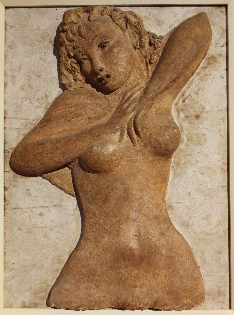 The bass-relief is made of plaster painted with the warm color tone of the earth in order to represent terracotta. The subject is a juvenile girl, as we can see by the tenderness and freshened of her curves, that act like she’s stretching or