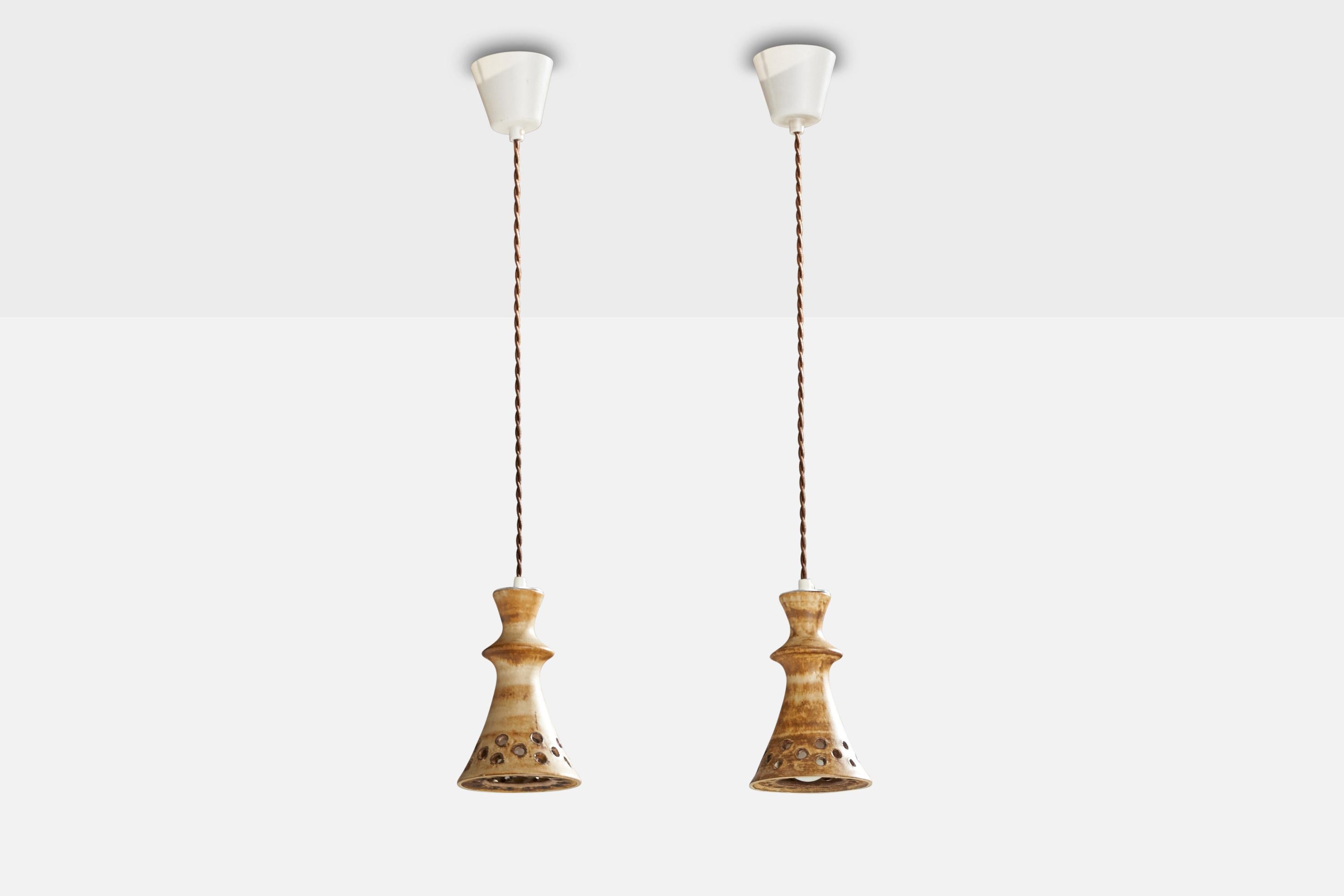 A pair of brown and beige-glazed stoneware pendant lights designed by Bruno Karlsson and produced by Ego Stengods, Sweden, 1960s.

Rewired.

Dimensions of canopy (inches): 3.00” H x 3.5” Diameter
Socket takes standard E-26 bulbs. 2 sockets.There is