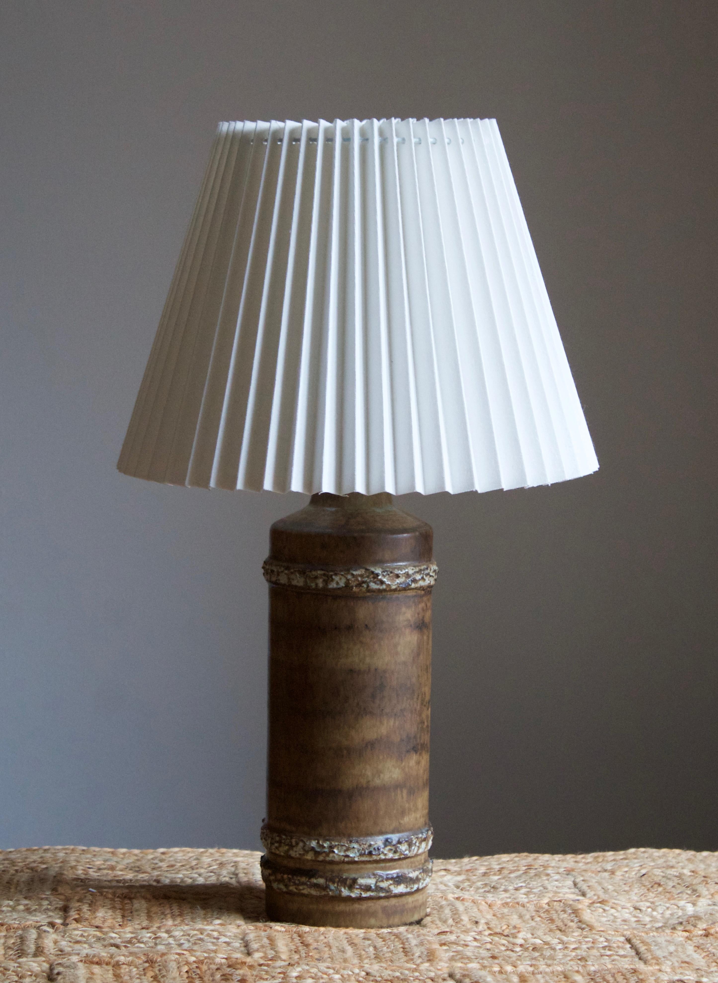 A sizable stoneware table lamp, executed by Bruno Karlsson at Ego Stengods Atelje. Stamped and initialed at bottom. 

Stated dimensions exclude lampshade. Height including socket. Sold without lampshade.

Other ceramicists of the period include