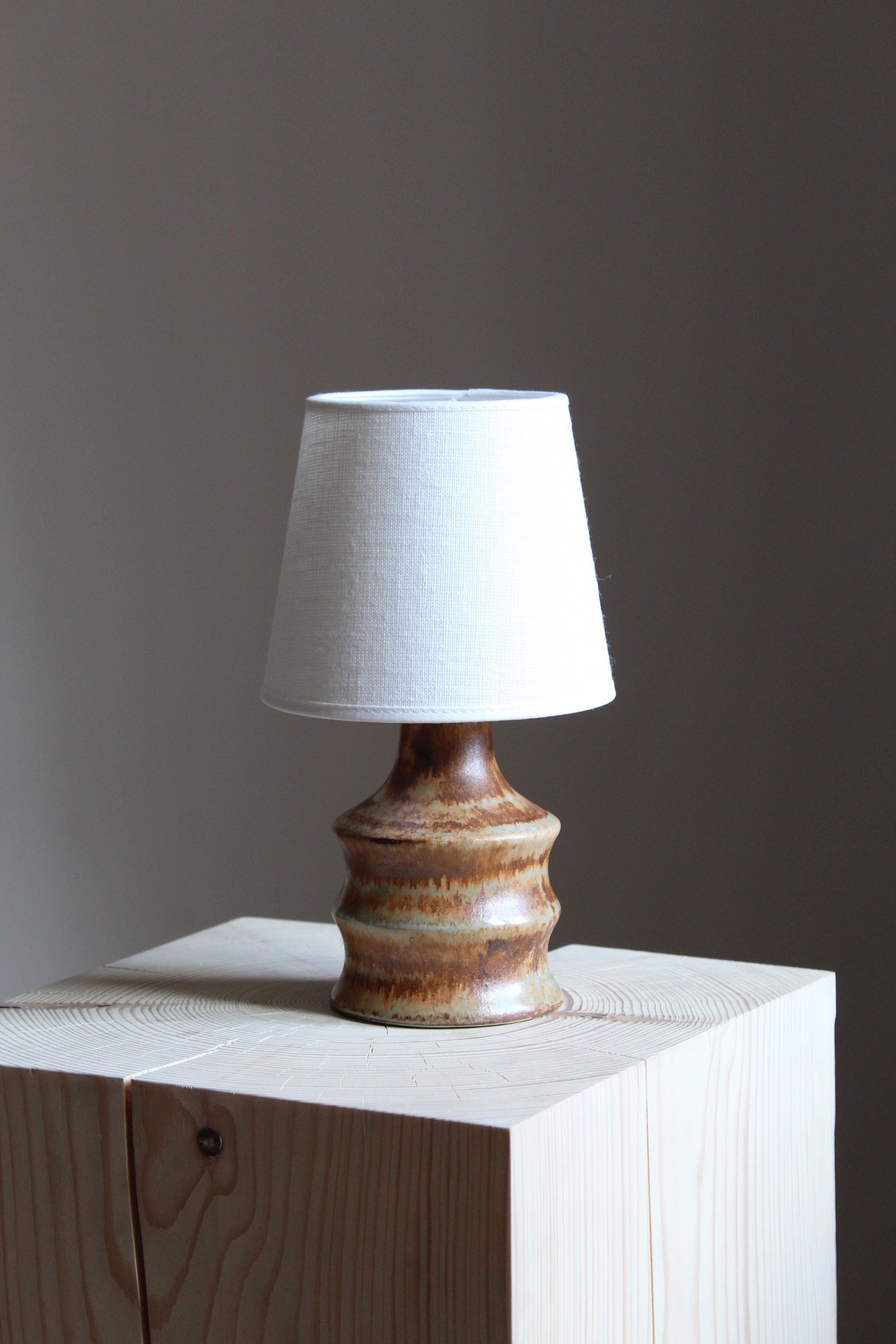 A stoneware table lamp, executed by Bruno Karlsson in abstract form and highly artistic brown / beige glaze. In his Studio, called 