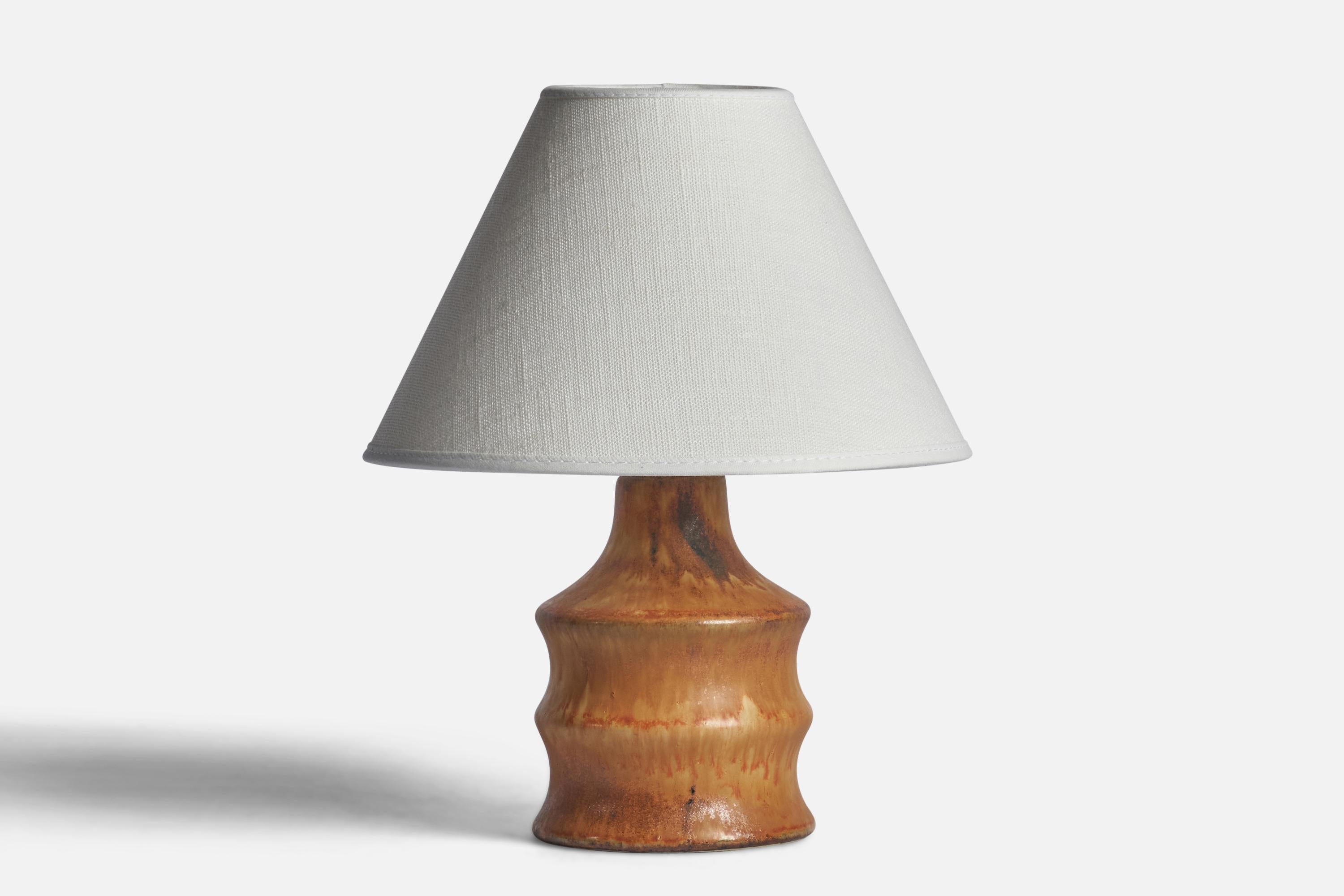 A small stoneware table lamp designed by Bruno Karlsson and produced by Ego Stengods, Sweden, 1960s.

Dimensions of Lamp (inches): 7” H x 3.65” Diameter
Dimensions of Shade (inches): 3” Top Diameter x 8” Bottom Diameter x 5” H 
Dimensions of Lamp
