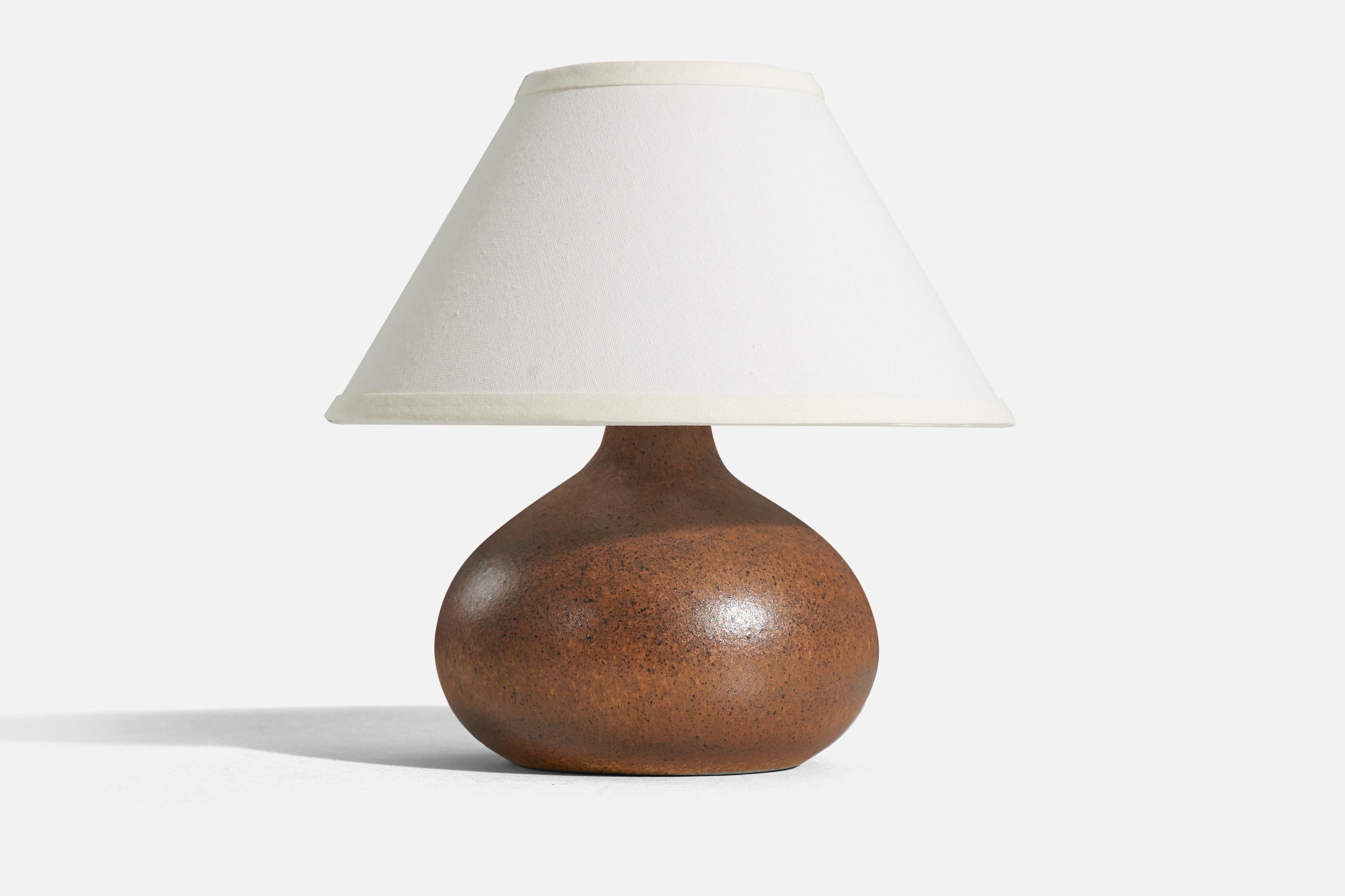 A brown-glazed stoneware table lamp designed by Bruno Karlsson and produced by Ego Stengods, Sweden, c. 1960s. It is stamped and signed on underside.

Sold without lampshade. 
Dimensions of lamp (inches) : 9 x 7.5 x 7.5 (H x W x D)
Dimensions of