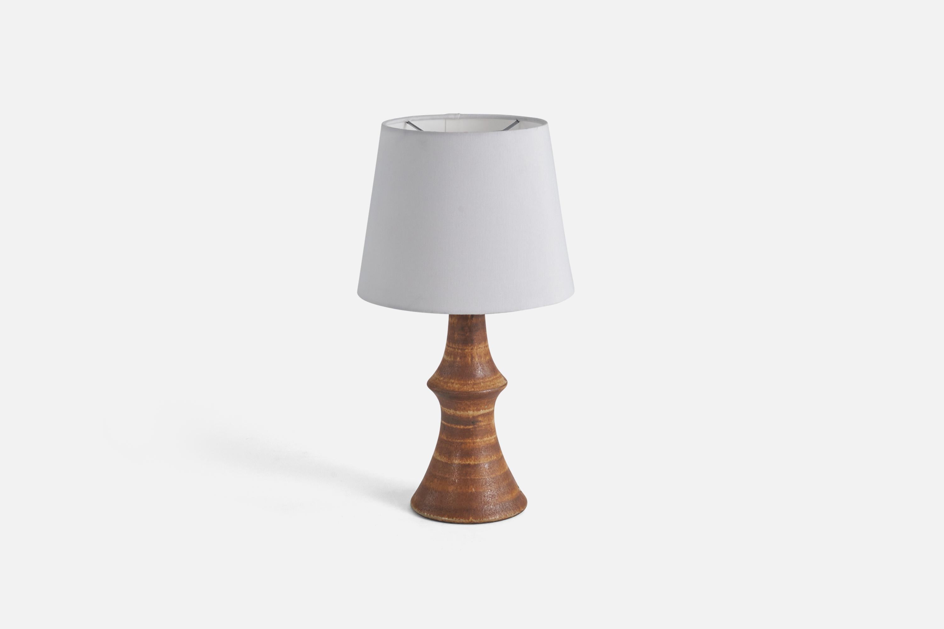 A brown-glazed stoneware table lamp designed by Bruno Karlsson and produced by his studio 