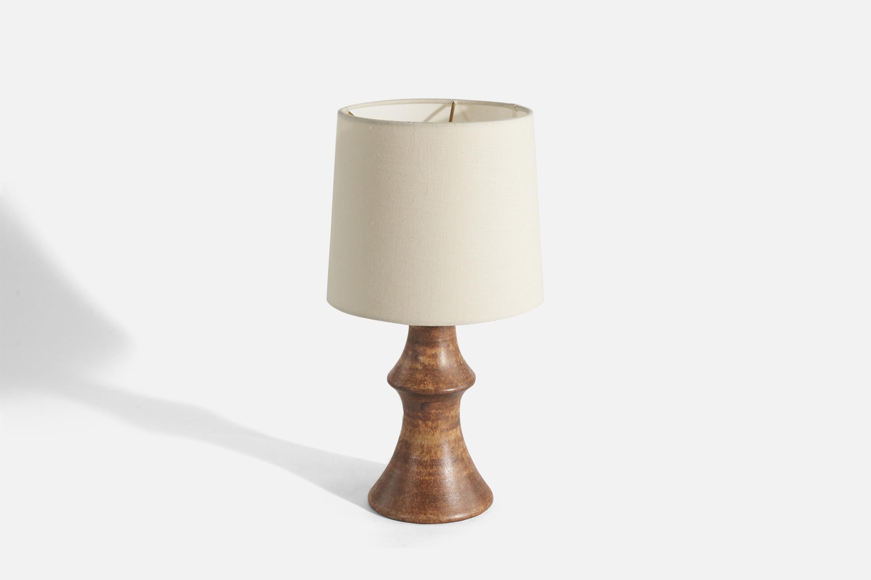 A brown-glazed stoneware table lamp designed by Bruno Karlsson and produced by his own studio 