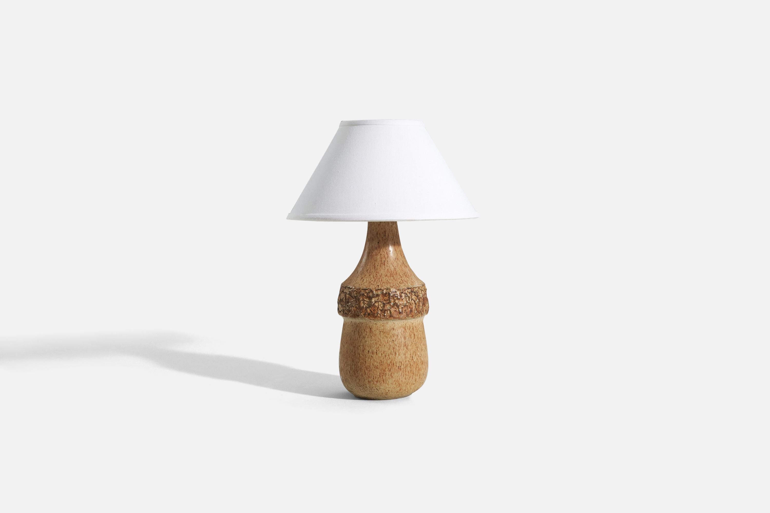 A brown-glazed stoneware table lamp designed by Bruno Karlsson and produced by Ego Stengods, Sweden, c. 1960s.

Sold without lampshade. 
Dimensions of Lamp (inches) : 14.875 x 6 x 6 (H x W x D)
Dimensions of Shade (inches) : 5 x 12.25 x 7.25 (T